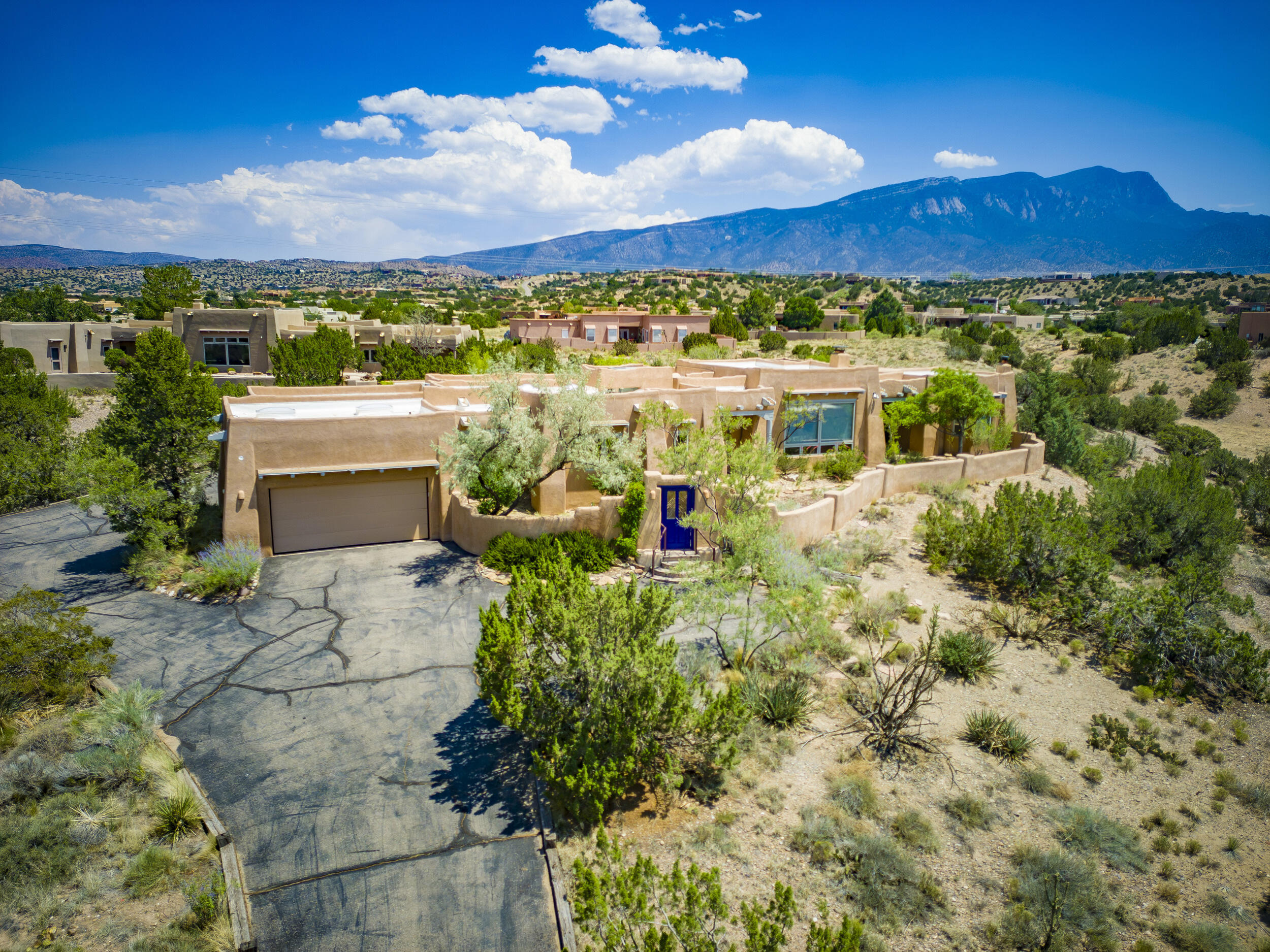 CONVENIENT CUSTOM SANTA FE STYLE! $830,000. Less than 4 miles from I-25, this spacious, classic home has outstanding views of sunsets, city lights & the Sandias! 2964 sq ft + oversize 3 car garage! Lots of southwest style details, including exposed beams & wood ceilings, saltillo tile floors (no carpet), wood windows & 10 skylights! Includes 3 bedrooms + office, 2 baths, spacious living/dining area, kitchen & nook. Perfectly framed western views from the spacious living room. 2 beautiful kiva fireplaces. Split floor plan; the primary suite has large bath with jetted tub & 2 covered patios to enjoy both views! Huge rear courtyard has dramatic Sandia views. Newer TPO roof & refrigerated air. Comfortable radiant (natural gas) heat & community water! On paved road, less than 4 miles to I-25.