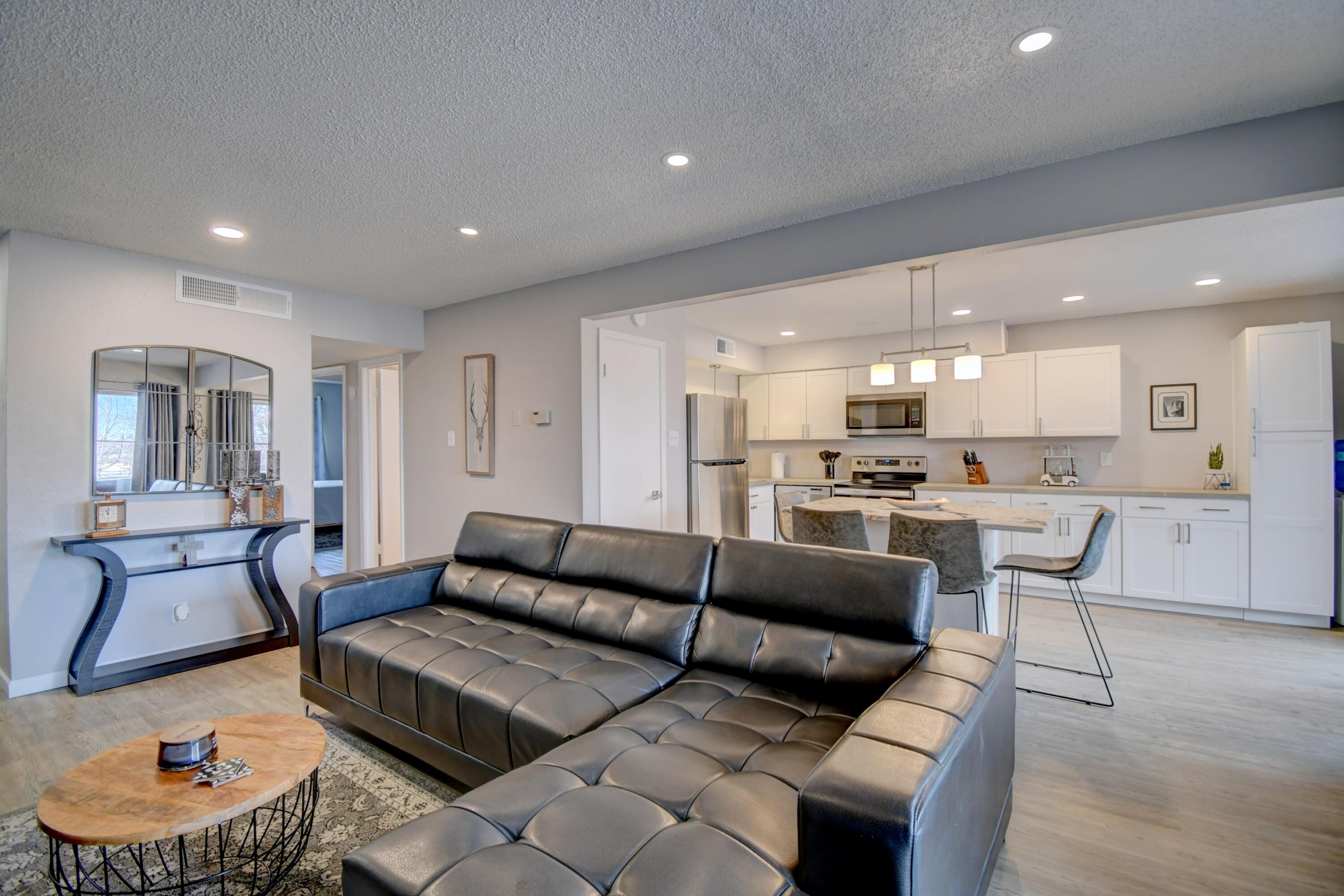Experience the beauty of New Mexico from this stunning, fully renovated condo in Paradise View Condominiums. Enjoy breathtaking sunrises & the Balloon Fiesta from your private balcony with Sandia Mountains views. The bright & open floor plan features a spacious kitchen island, cozy living room & updated amenities - a newer TPO roof (2022), windows, refrigerated air, & modern flooring throughout. Ideal location near Rust Medical Center, shopping, dining, & just a short distance to Paradise Hills Golf Course or The office. HOA takes care of common areas, roof, stucco,A/C, heating, water, sewer,& trash, giving you peace of mind. All you have to pay is the electric bill!
