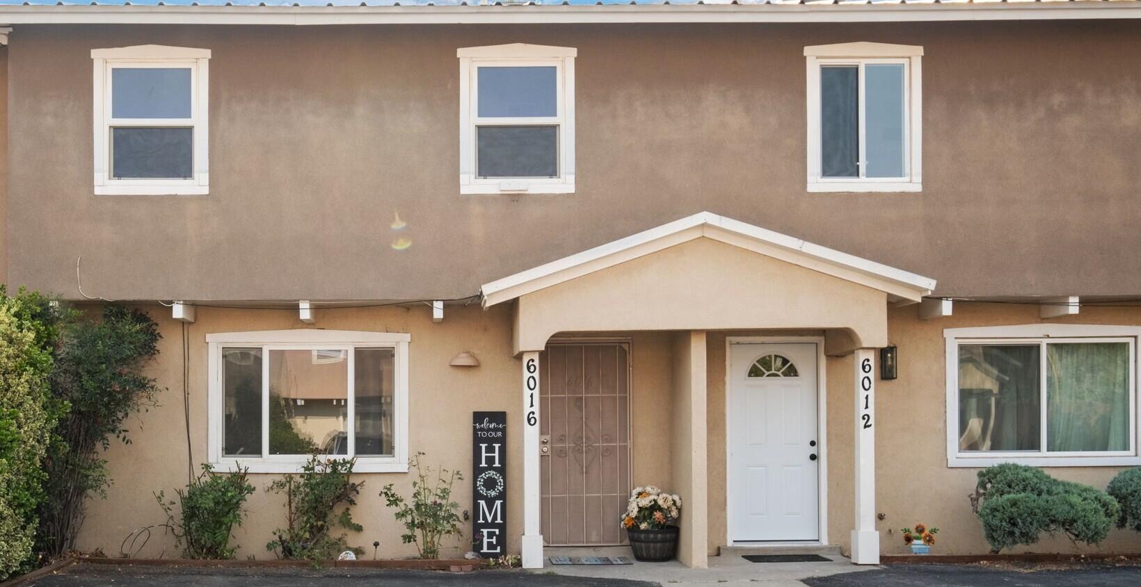Welcome Home to this light and bright gem in the heart of the North Valley. This move-in ready townhouse features tons of updates! The fully renovated kitchen is a chef's dream with new induction cooktop, upgraded cabinets and gorgeous granite countertops; the large pantry features new pull-out drawers and trim to match the kitchen; new carpet in bedrooms, hallway and stairs; new lighting and plumbing fixtures and new vanity cabinets in baths; fully fenced backyard with irrigation system; newer water heater; split system heating and refrigerated cooling to keep you comfortable all year round! Right next to beautiful Grecian Park and within walking distance of shopping, dining and the Bosque. Low HOA Covers Roof, Stucco and Common Grounds. Don't miss out come see it today!