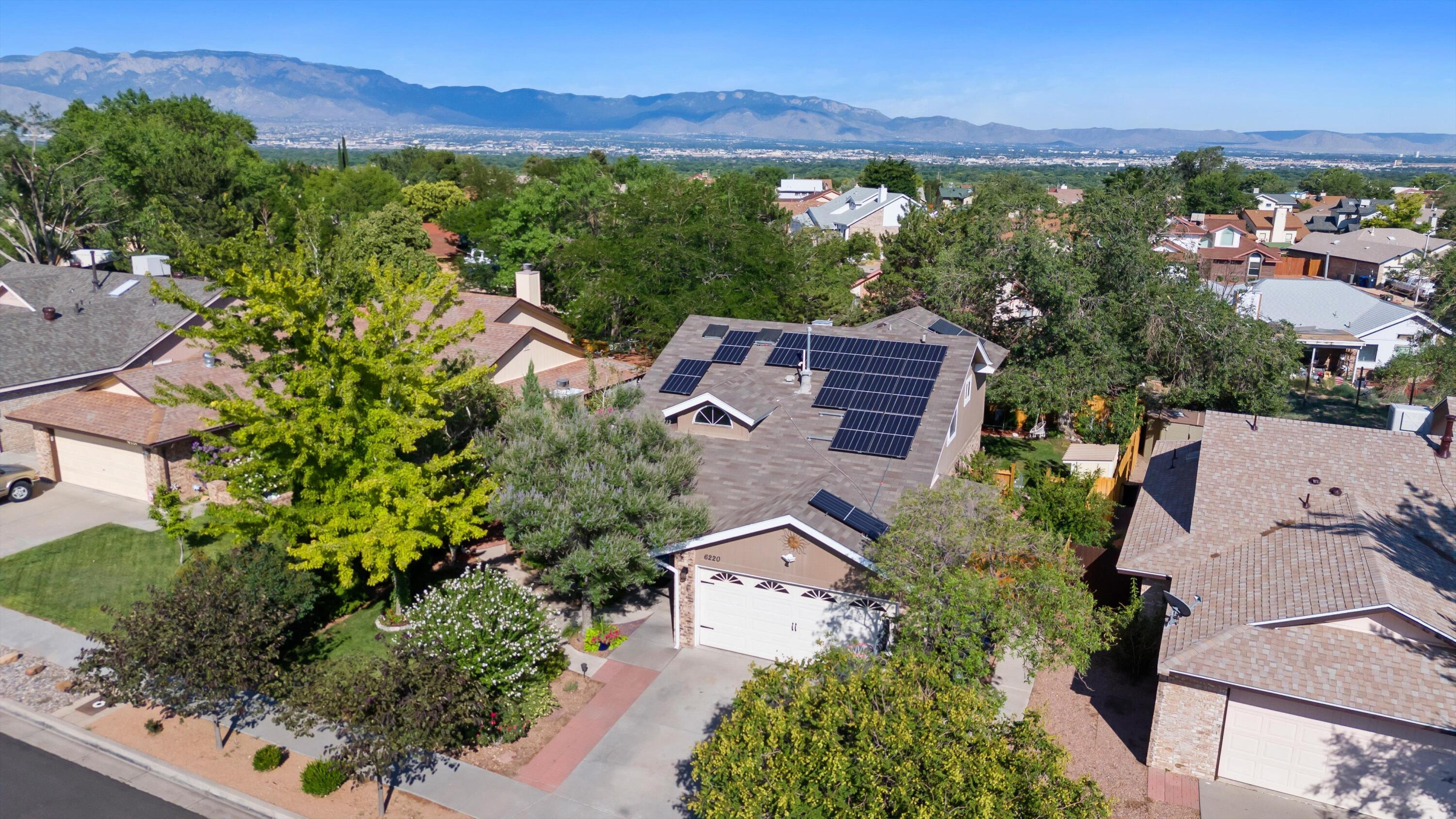 Welcome to 6220 Bridle St NW in Albuquerque, NM! It could be your own peaceful sanctuary. This beautiful 3-bedroom, 2-bath home spans 1,893 sq ft and features a spacious primary suite conveniently located on the ground floor. Enjoy energy savings with a 19-panel solar system. The stunning landscaping creates an inviting curb appeal, while the backyard is a true oasis--perfect for relaxing or entertaining. A handy workshop adds extra functionality. Nestled in a highly desirable neighborhood, you're just steps away from parks, shopping, and entertainment. Don't miss this perfect blend of comfort, sustainability, and location!