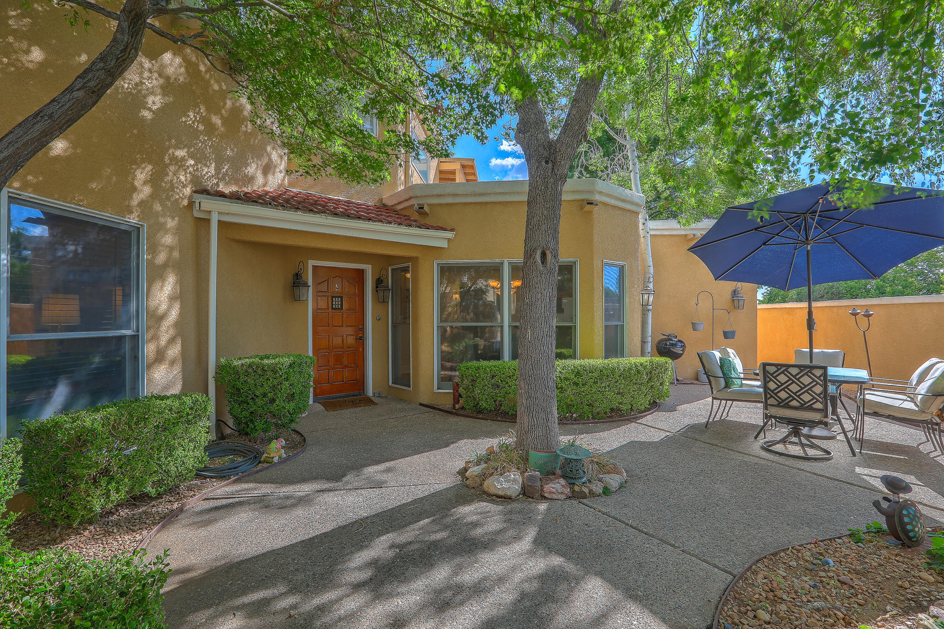Beautiful Tanoan home with lush front private courtyard and many amenities. Several updates throughout - including all new floors, doors, designer tile, window trim, designer paint, and custom wood blinds to convey. Dual Bar seating areas in immaculate chef's kitchen with double ovens, GE mongram 5 burner stove. Master suite  upstairs for a full owners retreat with jetted tub, separate shower and large California Closet. Outdoor balcony off master suite. Secondary master on main level with full bath, third bedroom with exquisite cedar closet. California closet storage in garage for exellent use of space. Newer water heater, roofing, and upgraded main water line. This is a come and see in the gorgeous and exculsive community.