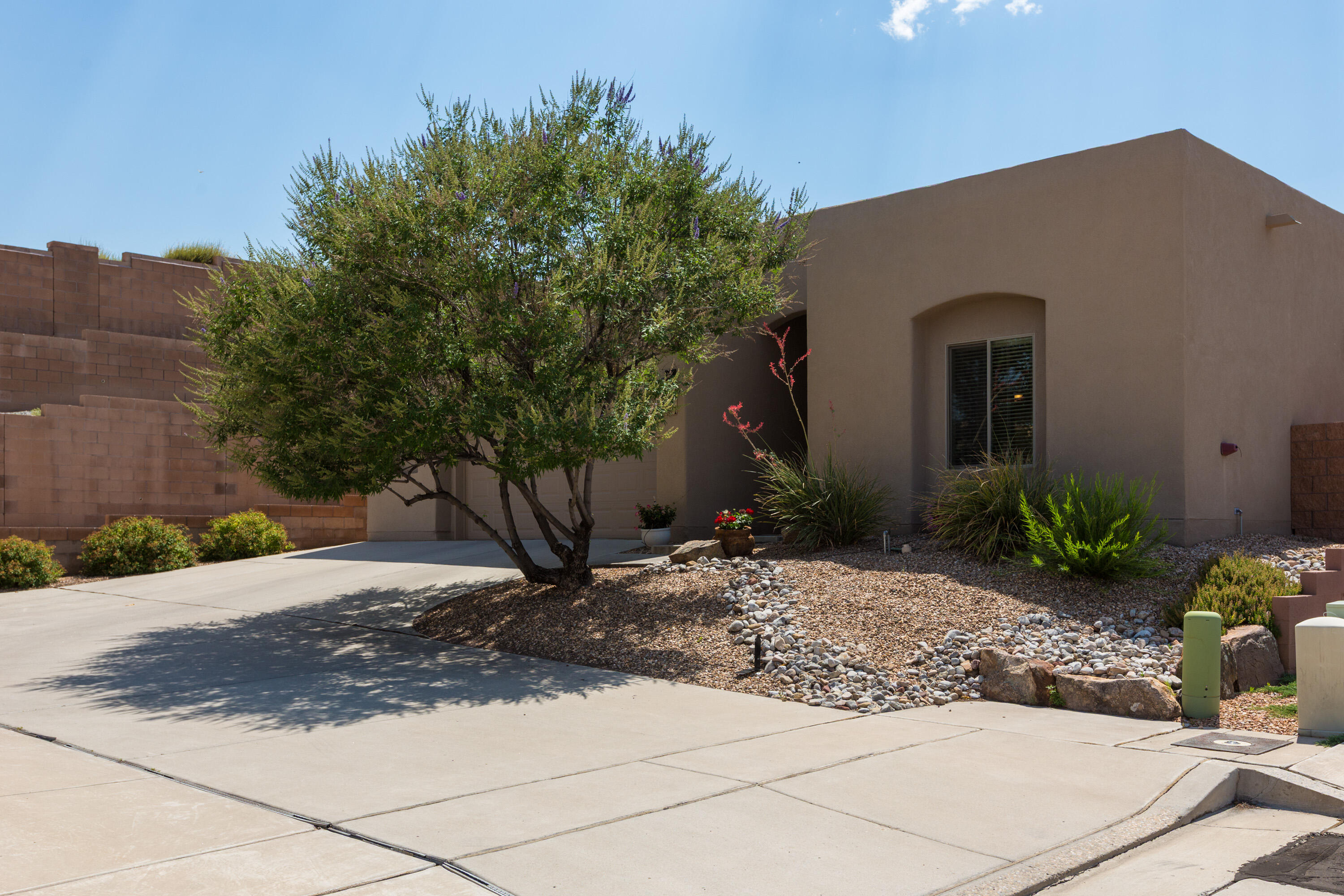 Located in the desirable Andalucia neighborhood, beautifully maintained single-story custom home features a spacious & thoughtfully designed open floor plan including a rare 2.5-car garage. Enjoy separation between the primary & guest bedrooms for added privacy. The spacious primary suite includes an en-suite bath with dual vanities, a walk-in shower, a separate garden tub, & a generous walk-in closet. The gourmet kitchen boasts a large island, granite countertops, stainless steel appliances, & an oversized walk-in pantry, perfect for everyday living & entertaining. The beautifully landscaped front & back yards are low maintenance. Nestled near the Bosque w/access to trails for walking & biking. This gem offers convenience to downtown, hospitals, restaurants, grocery stores, shopping etc.