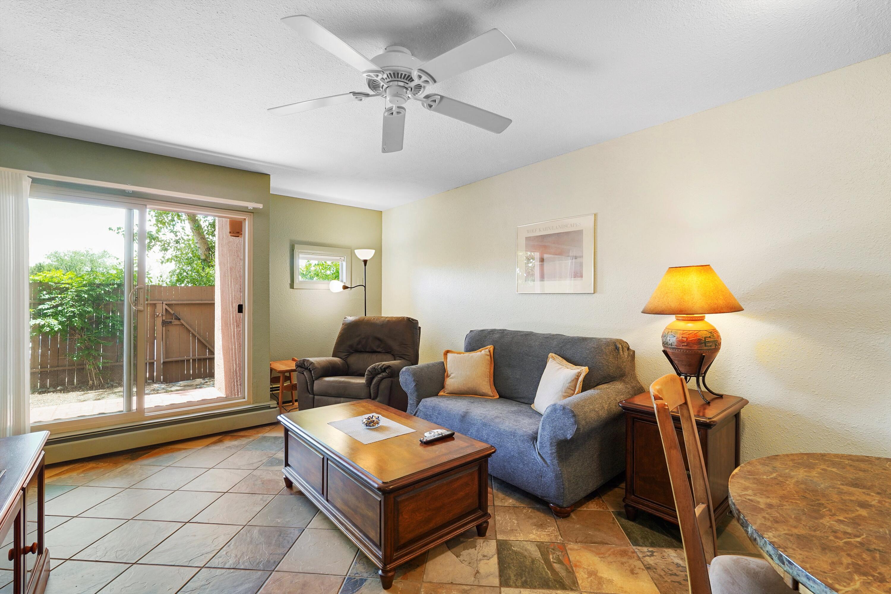 Welcome to 149 Calle Ojo Feliz, Unit B - a 1 of a kind 1-bed, 1-bath condo nestled in a peaceful, centrally located Santa Fe community. The living room and bedroom were modified to provide a more open concept. The kitchen offers ample cabinet space and flows nicely into the living space. Enjoy your private outdoor patio, ideal for morning coffee or evening relaxation. Located just minutes from the Santa Fe Plaza, shopping, restaurants, parks, and walking trails. The well-kept, highly sought after community includes landscaped grounds, laundry facilities, and off-street parking. Whether you're looking for a full-time residence, rental property, or weekend retreat, this condo offers comfort and convenience in a prime location.