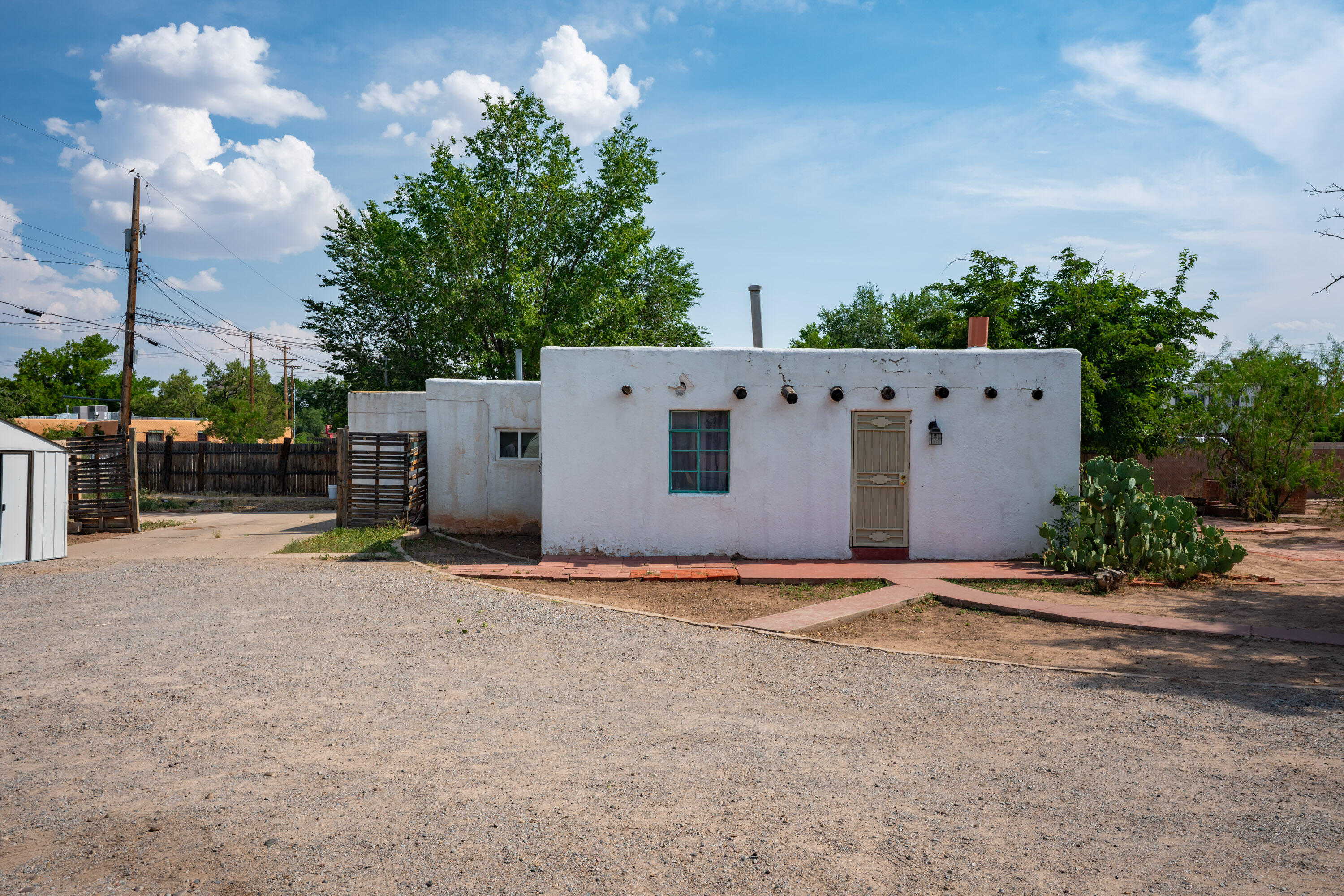 Don't miss this rare opportunity in the heart of Albuquerque's historic district!Nestled in a vibrant cultural hub known for its beautifully preserved Pueblo-Spanish architecture, this charming partial adobe home offers the perfect blend of history, character, and location. Just a short walk to the center of Old Town, you'll enjoy easy access to over 150 locally owned shops, galleries, museums, and restaurants, as well as the Abq Little Theatre. Situated on a generous 0.41-acre lot, the main home features 1,681 sq ft of living space with 2 bedrooms. An attached 639 sq ft casita provides excellent flexibility--ideal for guests, a home office, or rental income. You'll find a detached oversized 3-car garage offering ample storage and privacy.