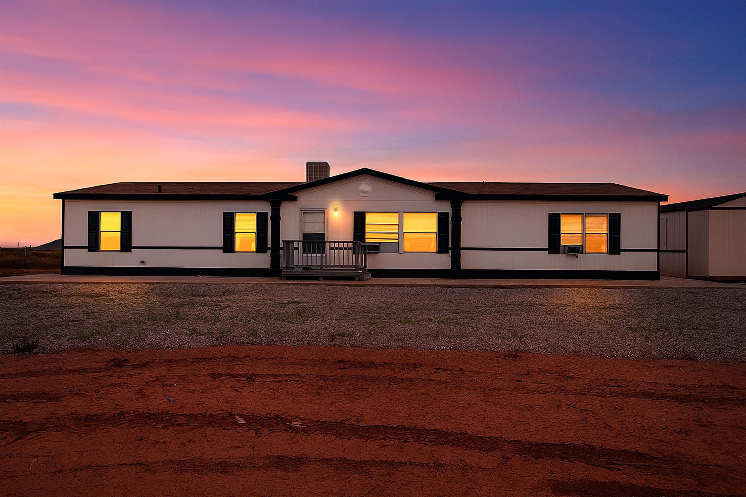 VAST NEW MEXICO SKIES 45 MINUTES WEST OF ALBUQUERQUE WELCOME YOU HOME! Lovingly maintained and move in ready, this 3 bedroom 2 bath manufactured home sits on an oversized lot in Laguna's desirable Highland Meadows. Enjoy a large family room plus separate living room with fireplace, built in shelving and sleek flooring. Kitchen pops with loving blue counters and a stylish backsplash. Primary bath has shower and relaxing garden tub. Outside find a garden shed, storage shed and room to breathe under starry nights. Peaceful high desert pace, cooler evenings and an easy highway run to Albuquerque for work and play. Schedule your private showing today!