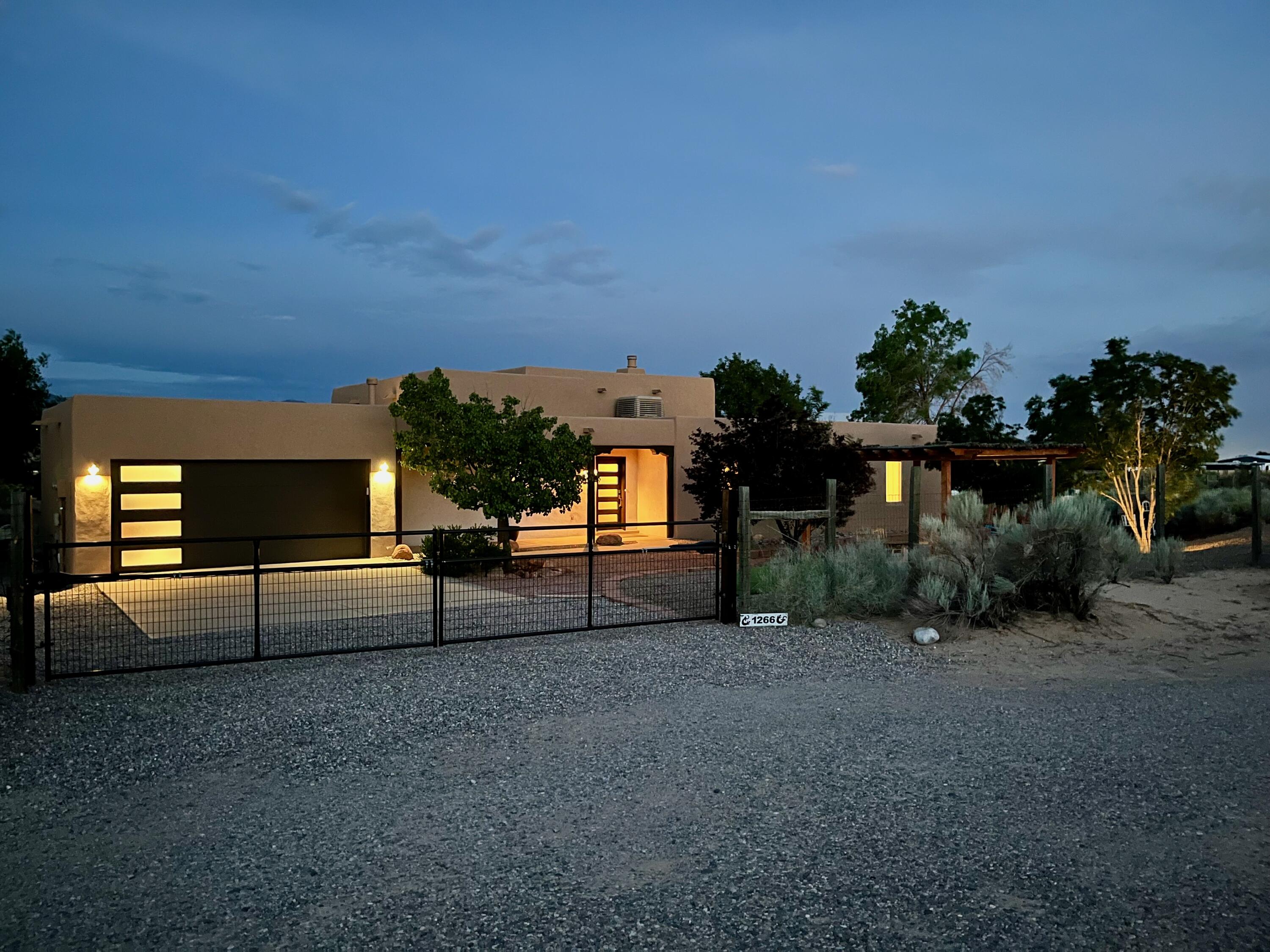 Don't miss your opportunity to own this 4 bedroom 2 bathroom contemporary Southwestern home in Corrales. The large .75 acre property is completely fenced with electronic gates and surrounded by large trees. The lot has space to build a pool, shop, horse barn, or possibly a casita if you desire in the future. Enjoy the private owners suite with hot tub, multiple patios, mountain views, RV parking, and so much more. Schedule a showing to see what the Corrales lifestyle has to offer today.
