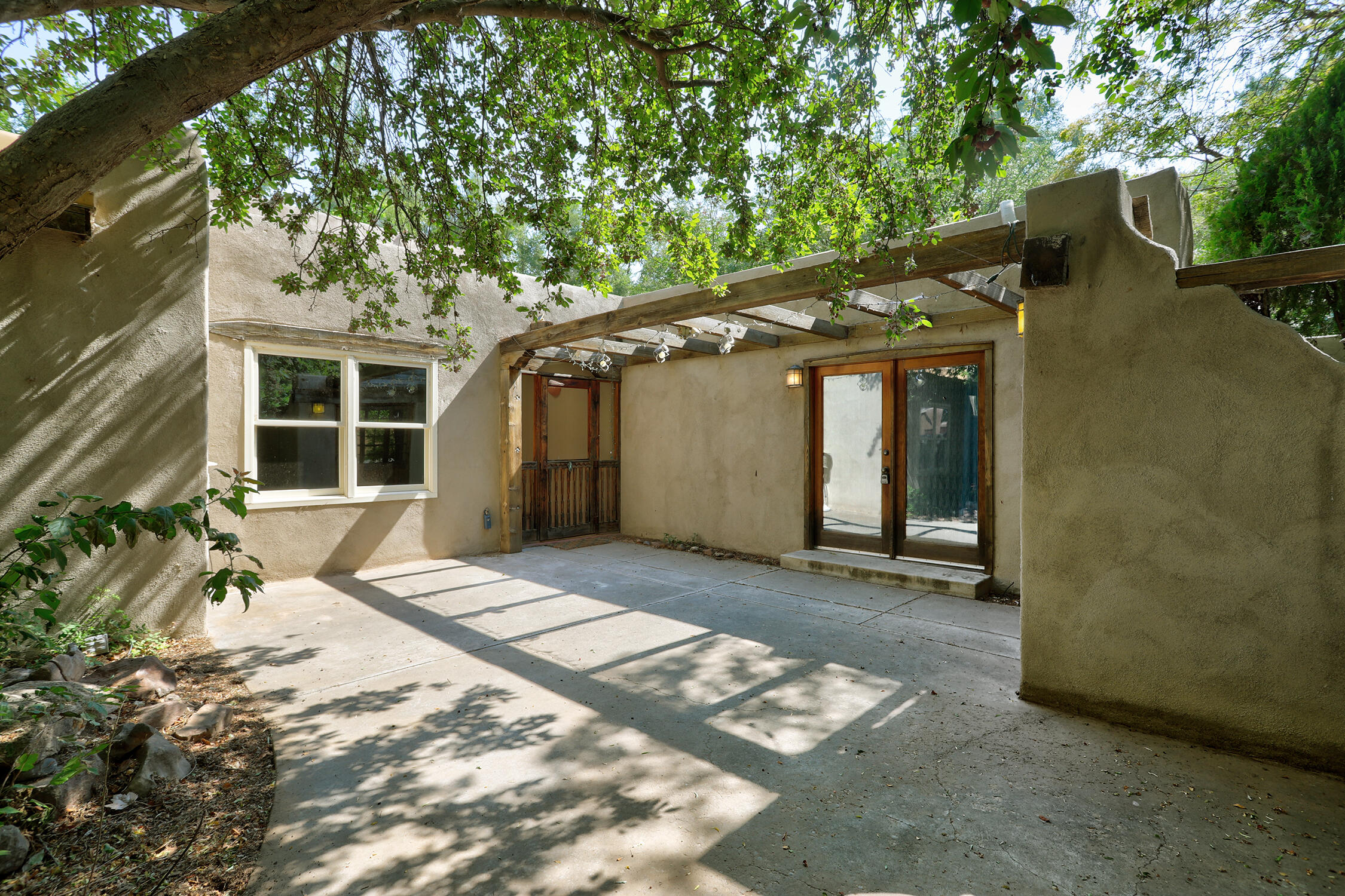 Experience timeless Southwestern Charm on a full acre in Peralta! This spacious home offers 4 bed, 4 bath plus an office (could be a 5th bedroom), 4 cozy fireplaces, 2 spacious living rooms one w/ beautiful raised beamed ceilings.  Well appointed kitchen with custom cabinetry, 6 burning gas stove w/ griddle, double ovens, and 2 sinks! The attached casita, connected by a breezeway offers added flexibility w its own entrance, fireplace washer, dryer, kitchenette, and private bath! Updates include 24 Panel Solar system (2018(), Andersen windows(2018), Stucco (2020), Roof (2020), New HVAC in main house (2018).  Primary bath haas brand new tile and paint! Recently connected to city sewer (2024).  Verdant spacious yard with a variety of fruit trees.