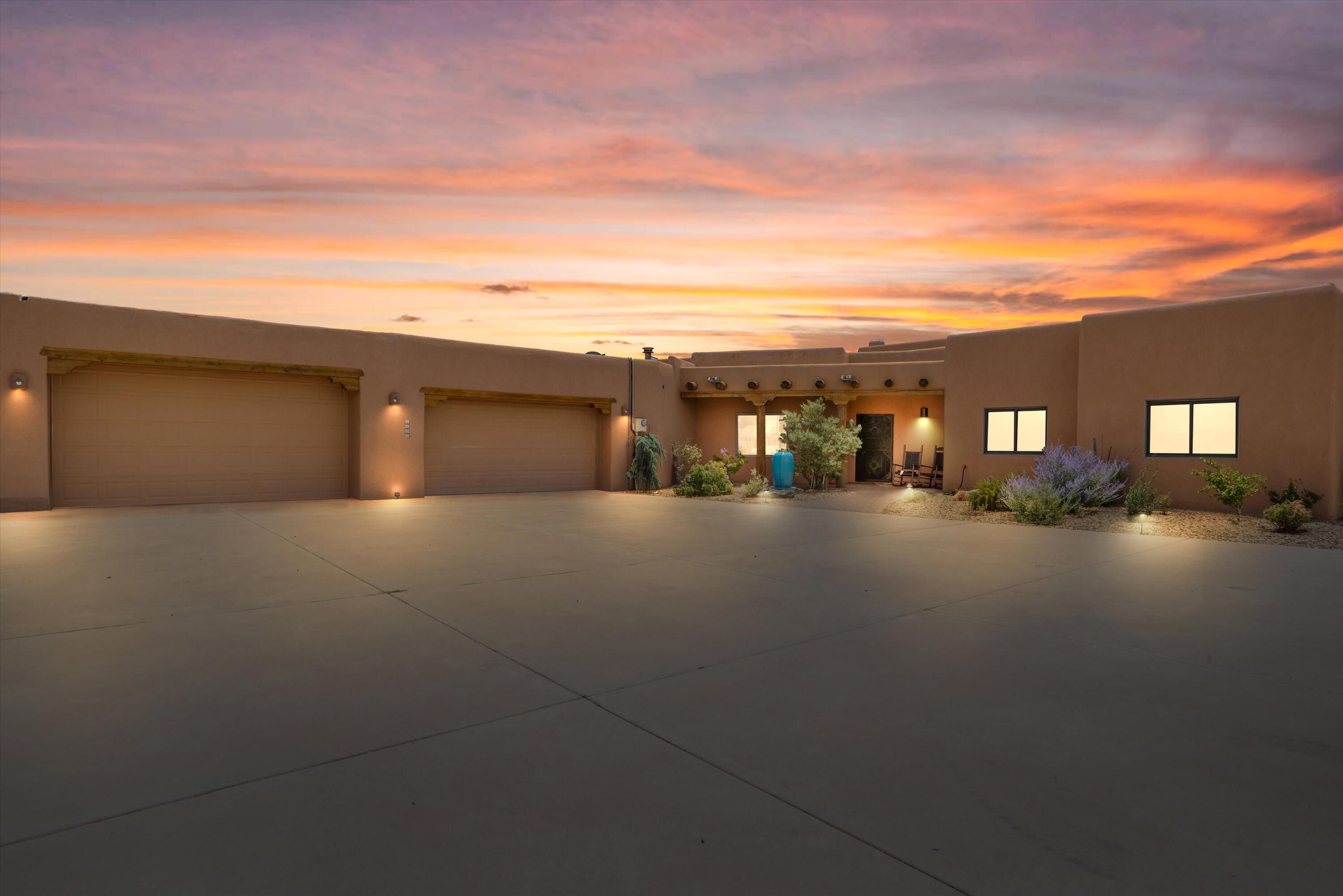 Come see this beautiful oasis with some of the best views in town! Enjoy stunning Sandia Mountain views from the comfort of your home. This spacious 4-bedroom property offers two primary bedrooms--one perfect as an in-law suite with its own living area, full bath, and private access to the yard and hot tub. The second primary also has backyard access to a covered patio. Features include low-maintenance landscaping, a storage shed with water access, formal and informal dining areas, four backyard entry points, and two custom Kiva fireplaces. Natural hand-sculpted wooden posts greet you at the entrance, with breathtaking wood beams in the living room and charming Southwest touches throughout.