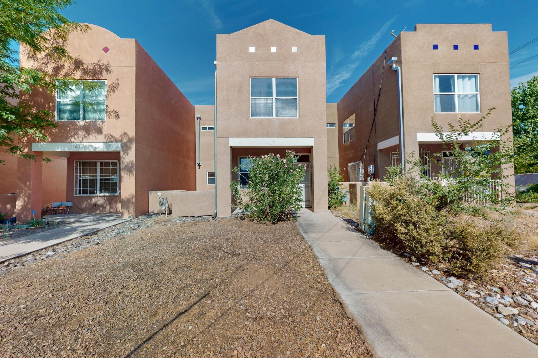 Welcome to this beautiful townhome in the desirable Ridgecrest area, perfectly located near Kirtland Air Force Base, UNM, VA Hospital, Albuquerque Sunport, and the vibrant shops and restaurants of Nob Hill. The backyard features garden beds and a mature shade tree--ideal for relaxing evenings outdoors. Inside, stay comfortable year-round with recently installed refrigerated air (2 years old). The kitchen offers a spacious bar with room for seating and a full dining table. The bright living room showcases engineered wood floors with large windows that fill the space with natural light. Upstairs, the primary bedroom includes two closets and leads to a private balcony with golf course views- an ideal place to take in New Mexico's stunning sunsets. Two neighborhood parks close by!