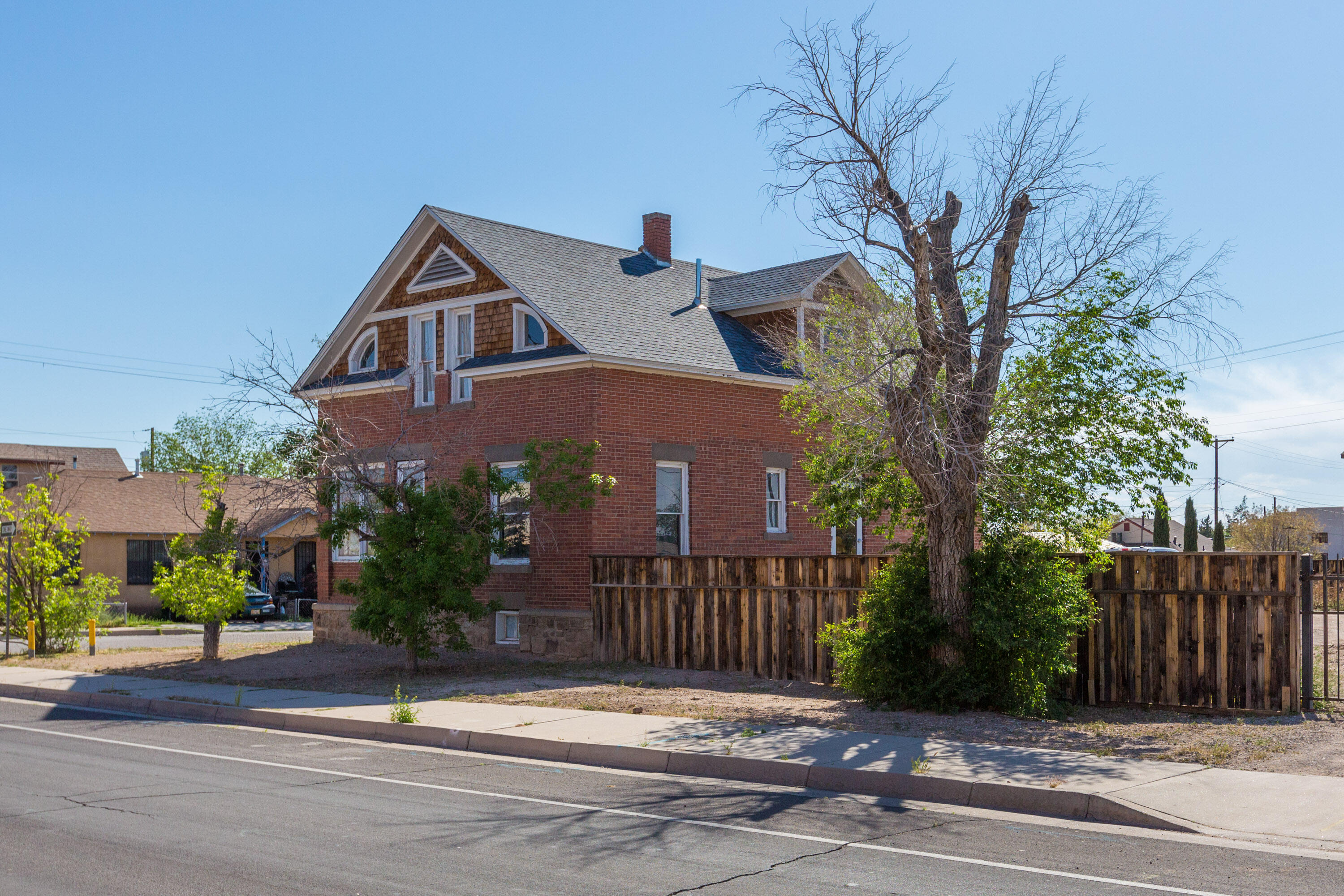 Located in Downtown Albuquerque's Wells Park neighborhood on a large corner lot, this unique live/work property (MX-T zoning) offers a blend of historic charm & modern amenities. This property has been continually updated while preserving its character. Ample parking, fenced & gated, with room to park multiple RVs (2 backyard access gates). The adjacent vacant lot is also for sale. The property offers 3 separate & unique apartments, fully furnished, perfect for short or long-term rentals. Consistently rented over the past 4 years. Sculpture & outdoor storage building convey. Lighted patio area. Accessibility ramp on north side. Property is within a character protection overlay zone (CPO#12). Also listed in Residential Income MLS 1020638. Adjacent vacant lot available MLS 1066015.