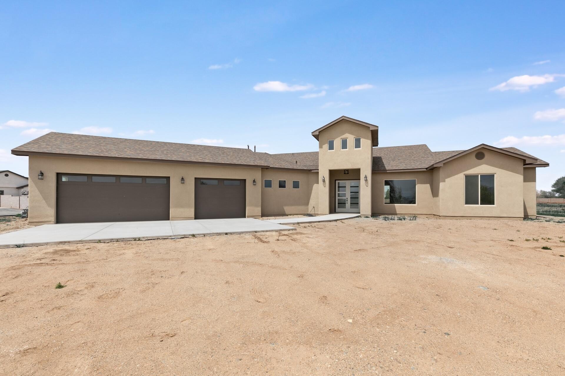 Stunning custom home located in a desirable gated neighborhood. This home sits on a beautiful 1.5 acres with an oversized 3 car garage and grande entryway. As you walk into the foyer you will find a large living space and open kitchen with plenty of cabinet and pantry space. Owners suite is has its own private entrance to the covered patio, perfect location to watch the NM sunsets!  Granite counter tops and custom title floors throughout the home. Schedule your showing today!