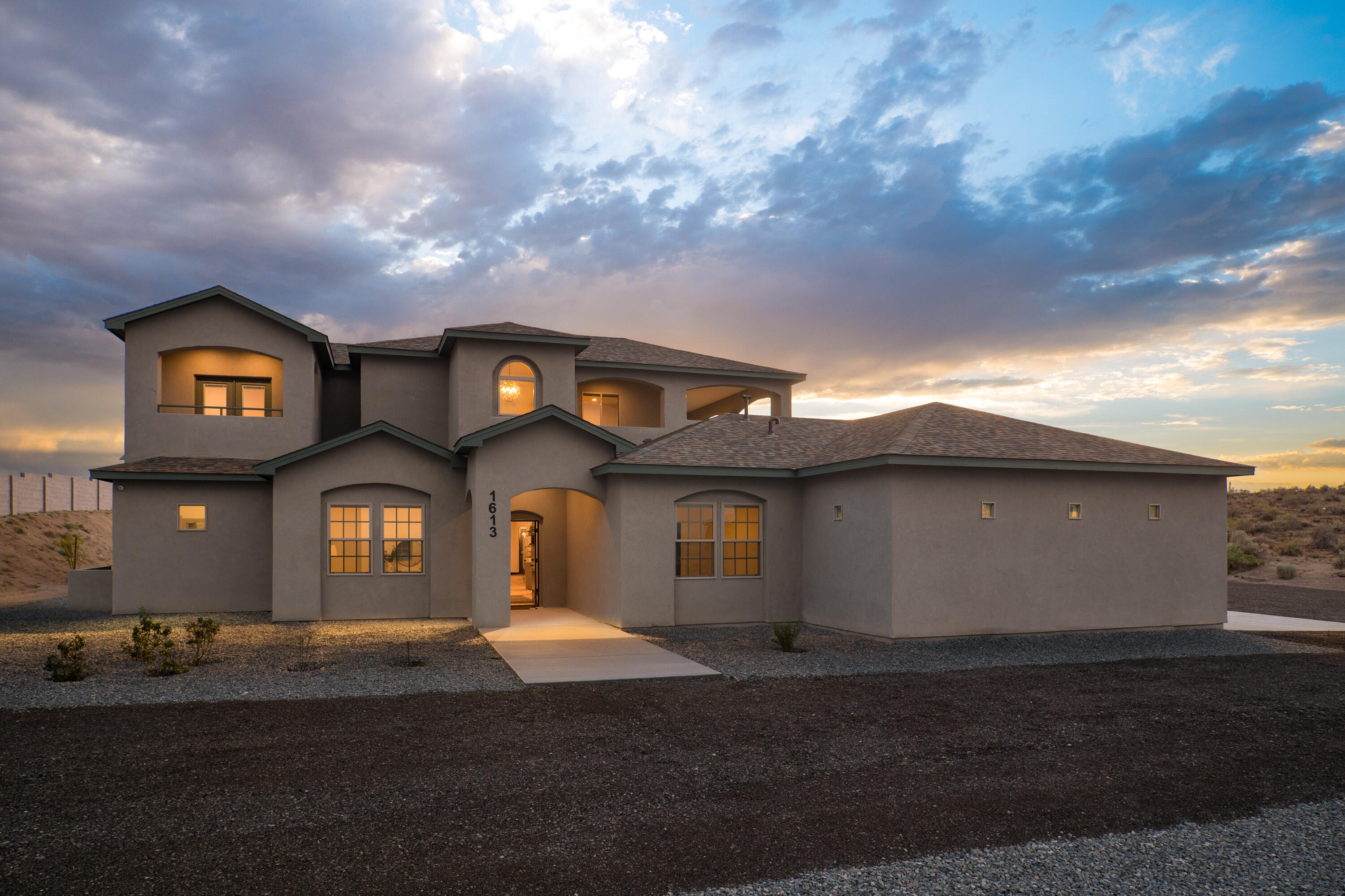 Seller will contribute $30K towards an interest rate buy down, or Seller will consider Owner financing!  Construction was just completed on this incredible custom home in Rio Rancho Estates. Beautiful clean and contemporary finishes create a neutral backdrop for luxury living. Custom finishes include beautiful hardwood floors, white shaker style cabinetry, crisp white quartz countertops, classic subway tile, and high end stainless steel pro-style appliances. Multiple living, dining and entertainment spaces make this flexible floor plan ideal for many different living situations including large families, multi-generational living, or work from home. The primary suite is a dream and offers a luxurious bathroom with a walk in shower, free standing tub, and large walk in closet.