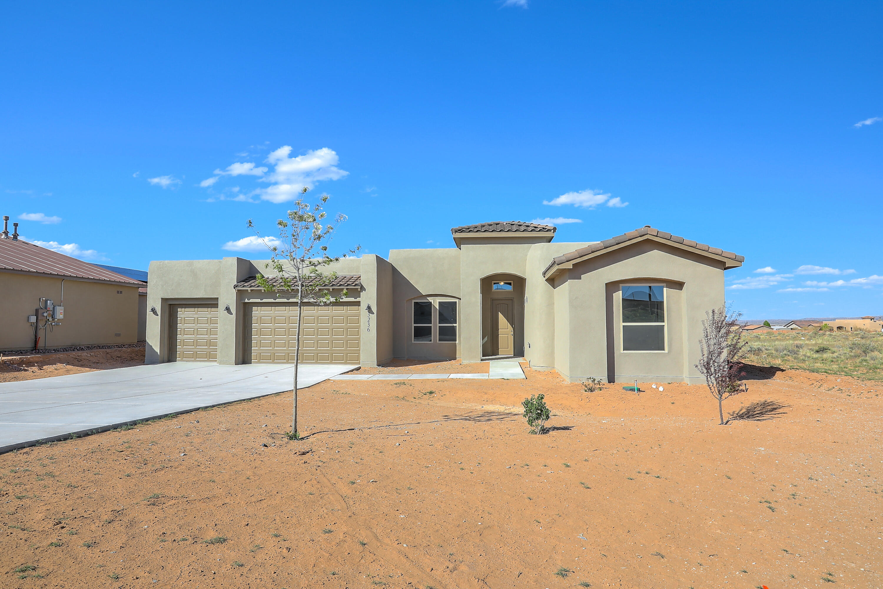 Newly Completed New Construction. This gem sits on a half acre with paved roads, all city utilities, and a view of the Sandias from your back patio. The home features a separate wing for bedrooms 2 and 3, while the master enjoys views out the back.