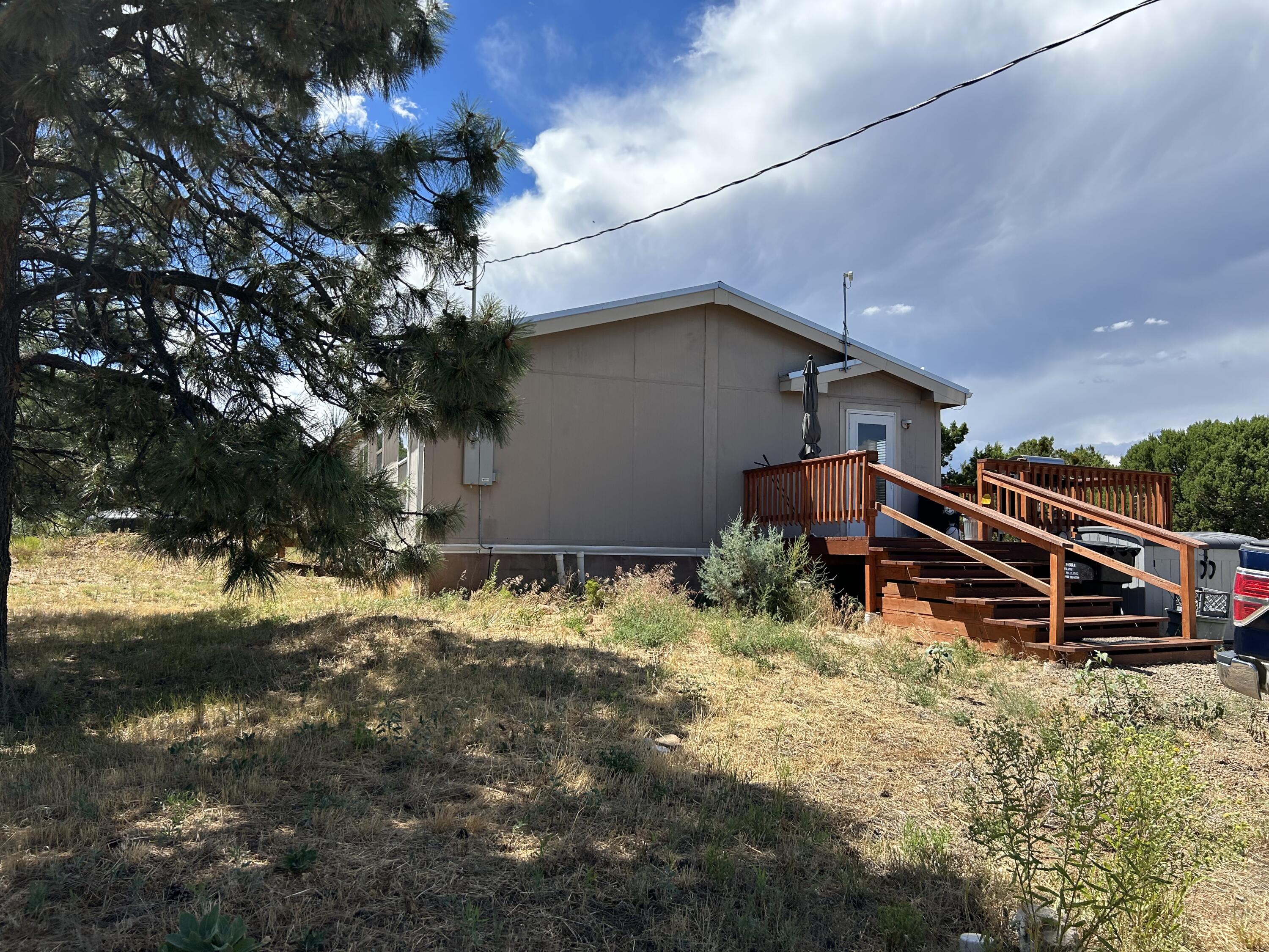 Welcome to the East Mountains.  This home is a short 35 minute commute Albuquerque.  2 bedroom 1-1/2 bathroom on 2.69 wooded acres.  Open floor plan with large kitchen... Metal roof and custom decks .  This is a must see.   This home is on a water haul with two tank and system 3600 gallons.