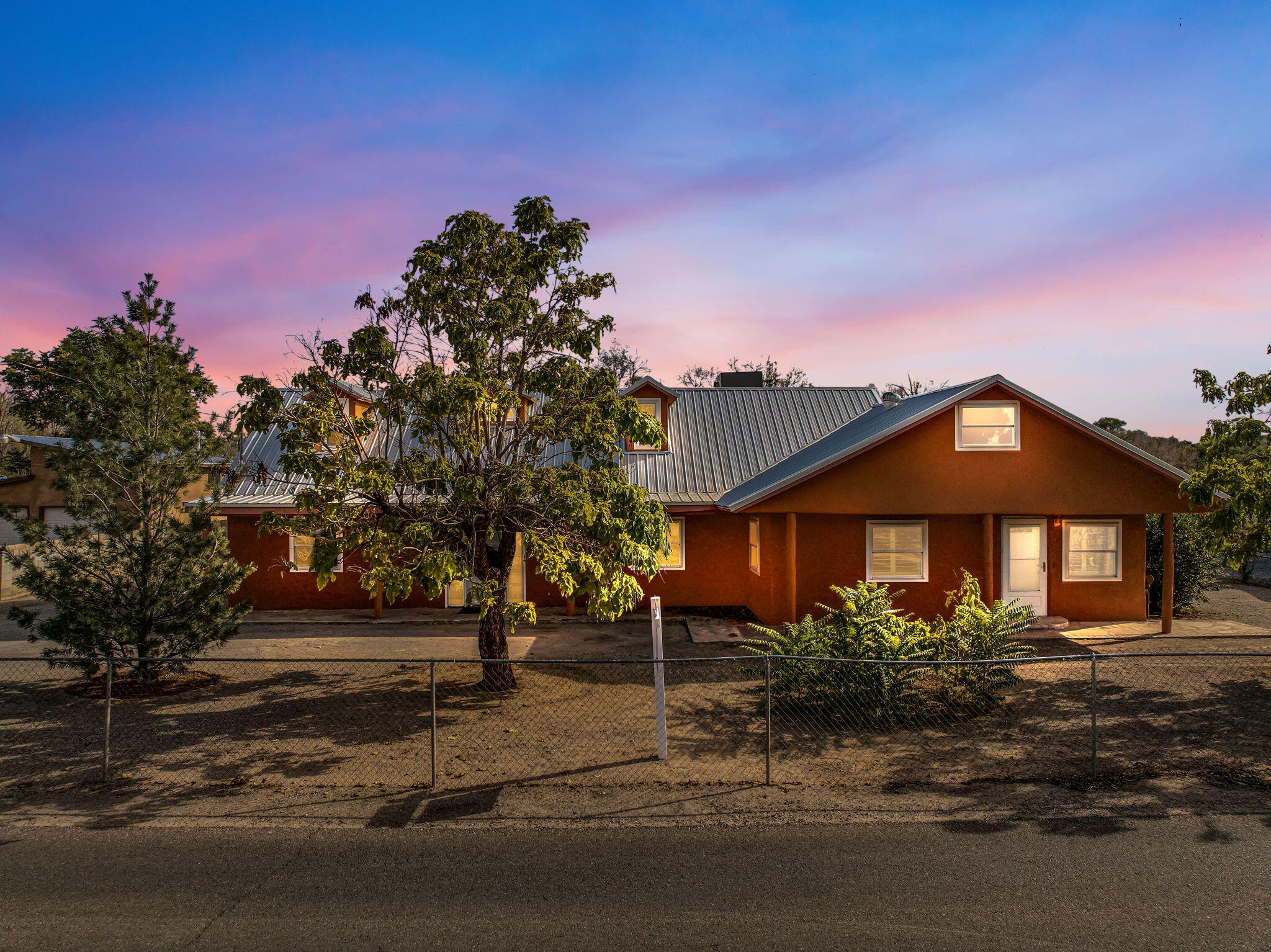 **Affordable lending program offered when financing with Waterstone Mortgage**Situated near the tranquil village of Los Ranchos de Albuquerque with vast outdoor activities, wineries, markets, spas, and convenient access to I-25, you will find this well-appointed 3-bed 3-bath home resting on a 1/4 acre lot with mature trees and a sizable storage shed. Enjoy the views of farmlands and the majestic Sandia Mountains through modern windows with custom shutters and a relaxing covered patio. This well-loved home has spacious living areas and a gourmet kitchen with white cabinetry and a large island. The owned solar panels will add to energy saving costs. This is a must see home, schedule your tour today!