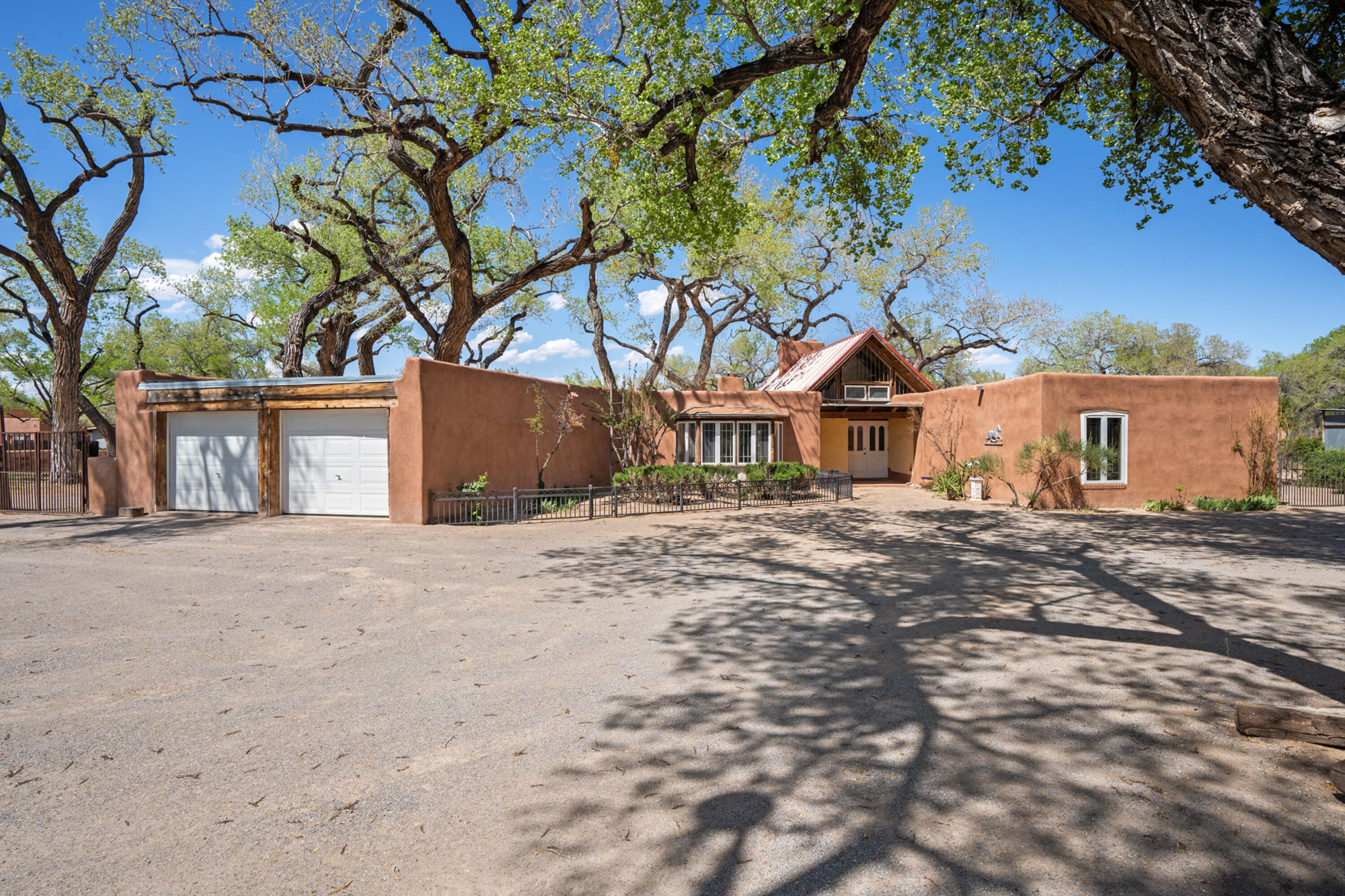 Corrales Tranquility!  Eastside Bosque location! This exceptional 7.22 acre property has been the home of Tamarisk Farms an equestrian property.Nestled under the cottonwoods is a 3200sf adobe designed by George Pearl, & a 884sf one BR casita.  Good bones, needs update. A well designed center island 5 stall barn w/runs, tack room, wash rack, & a carport for hay storage.  A separate building for hay storage or equipment.  3 large turn outs w/run in's, app. 60 X 180. each.  Pasture, and immediate access to the trail system & the 633 acre Corrales Bosque Preserve.  Gated entry from Quail Trail & a separate entry from Bosque Road.  Northside of property is Cottonwoods w/a 10 ' access for neighbors to access open space. Come fall in love!  This is truly the best of what Corrales has to offer.