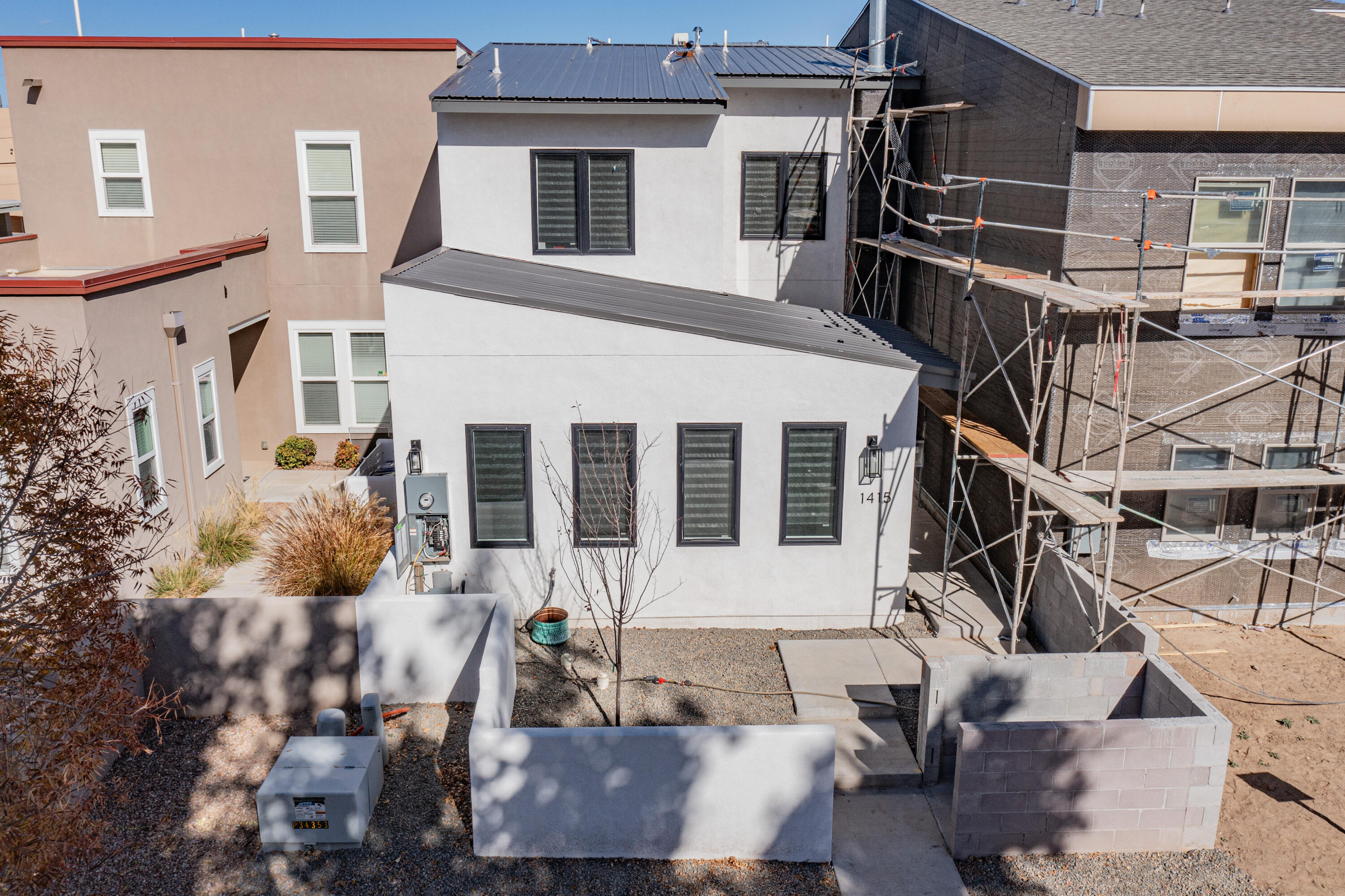 Impeccably crafted, this newly completed luxury townhome, enriched by builder occupancy, boasts a coveted Casita Currently bringing in $2,300 mo. as Vacation rental and always booked. Nestled in the prestigious Huning/Albuquerque Country Club Neighborhood, it provides unparalleled access to ACC, Tingley Beach, ABQ BioPark, and the vibrant tapestry of dining, cafes, shopping, downtown businesses, and government buildings. The versatile zoning permits a seamless live-work integration, allowing for an office, salon, studio, or an additional bedroom at the front with a private entrance and bath--an embodiment of both sophistication and practicality.  Get your showing scheduled!