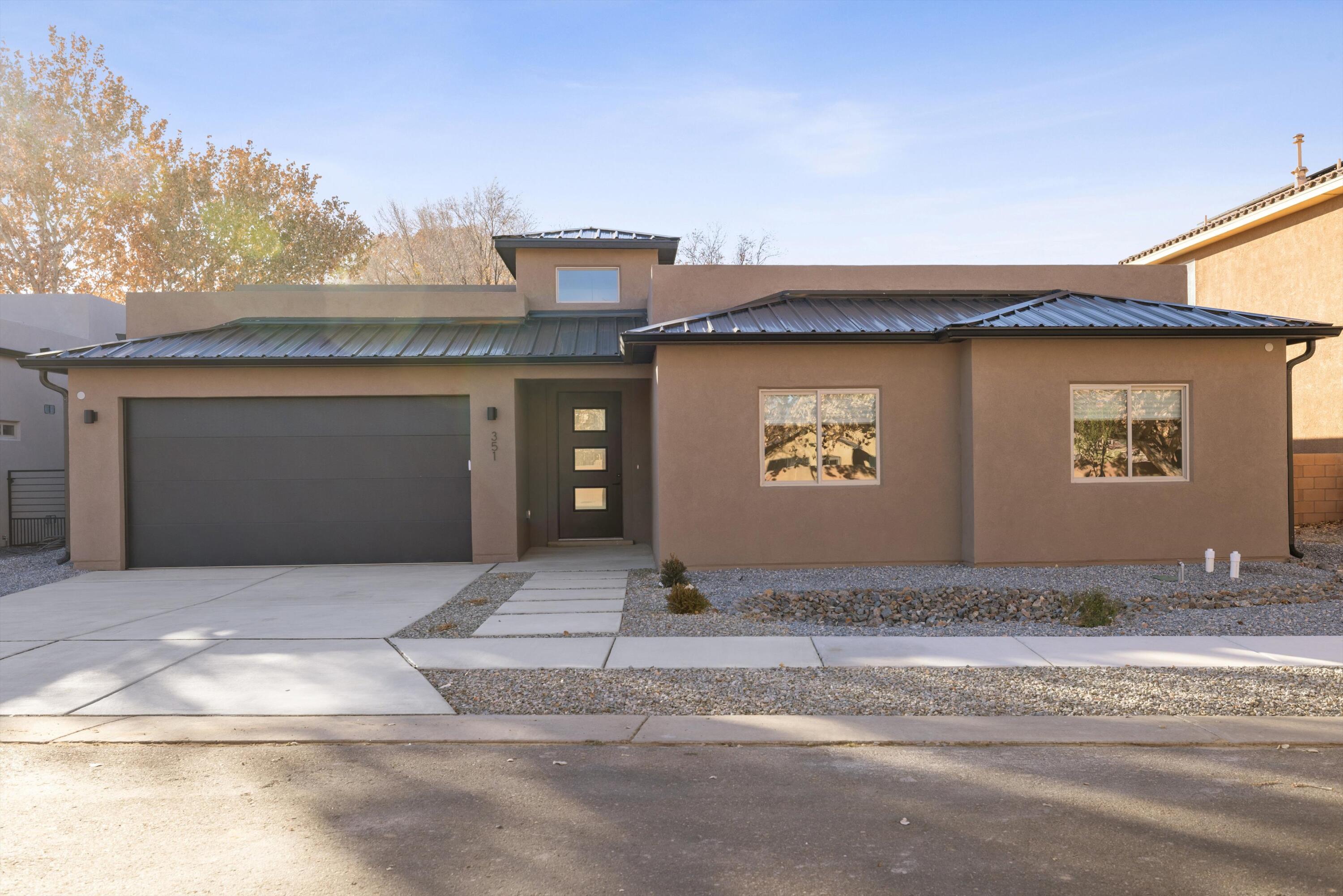 **Special Financing Available**Welcome to a contemporary masterpiece nestled in the heart of Albuquerque.  This custom-designed home boasts a seamless open concept floorplan, accentuating modern living.  The centerpiece of this home features an oversized island, perfect for culinary creations, complemented by a chic wet bar for effortless entertaining.  Experience luxury and sophistication in every detail of this architectural gem.