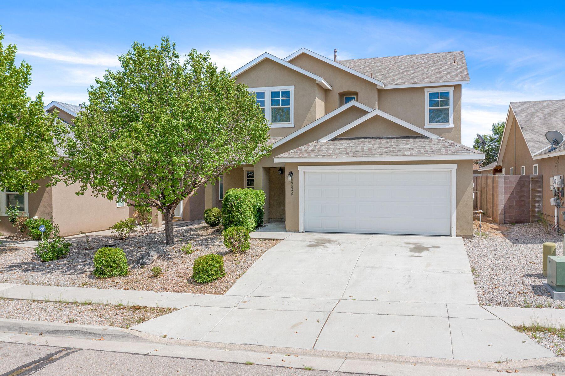 Beautiful two-story home, recently renovated. It features two living areas, a cozy gas fireplace, landscaped yard, and a covered patio for grilling.  HVAC is only 2 years new! The location is within walking distance to parks, and CNM West, offering easy access to outdoor recreational activities. This type of home is appealing to those who enjoy a comfortable, modern home with outdoor amenities and convenient location.