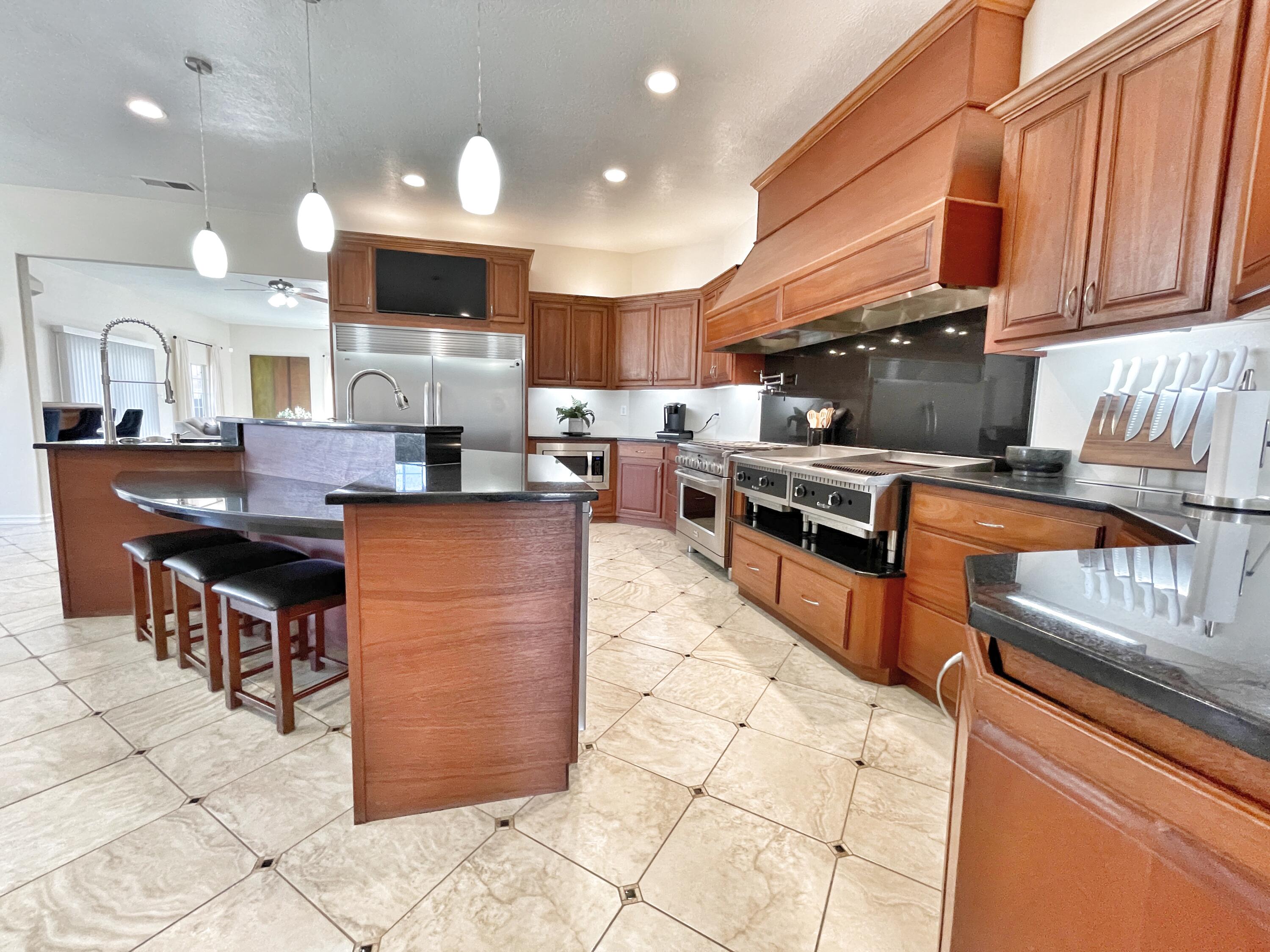 **2.75% VA assumable loan for qualified borrowers!** You must see this beautiful N Valley gem in person to appreciate it!  Fall in love with your dream chef's kitchen. The 36'' GE Monogram Stove 6-18k btu burners w/reversible wok feature, Centaur griddle & Broiler has a custom 8' built-in range hood. The built-in stainless steel Kenmore freezer refrigerator combo frames this custom kitchen perfectly! This spacious floor plan offers large bedrooms & ample storage. An entertainer's delight w/ a wet bar featuring a 3 keg Beverage Air kegerator/fridge, Manitowoc Ice Machine, 6 dispenser soda wand & bar sink. The HUGE laundry room will accommodate your dble stacked washer dryer sets. Refrigerated air and multiple heat sources.  It is even more impressive in person so come take a look!