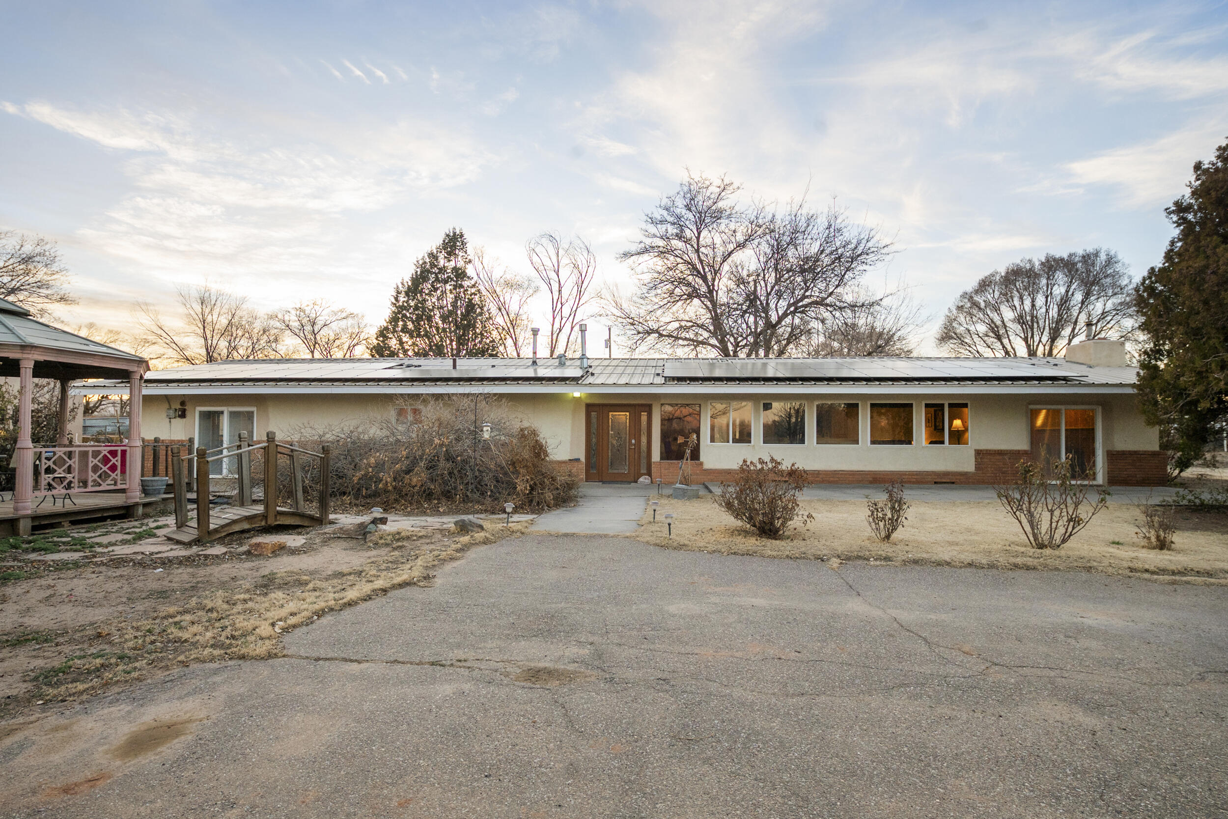 Welcome to this oasis under the New Mexico sun!  The sprawling 6 acre property located right off of Highway 314 is a must see!  The charming farmhouse showcases an open modern kitchen with a HUGE granite countertop island and lots of cabinets for storage.  Outdoors you'll find a large 6 car garage which will give you ample space to store your most prized possessions.  The massive metal building comes with radiant heating, kitchenette, bathroom and can be reconfigured from the kennel and office to fit your needs.  Lastly, you'll fall in love with the outdoor living area and your very own pond!  The outdoor kitchen, dock, bunkhouse, zip line and fishing will have you entertaining your family and friends all summer long!  You're imagination will run wild with the endless possibilities!