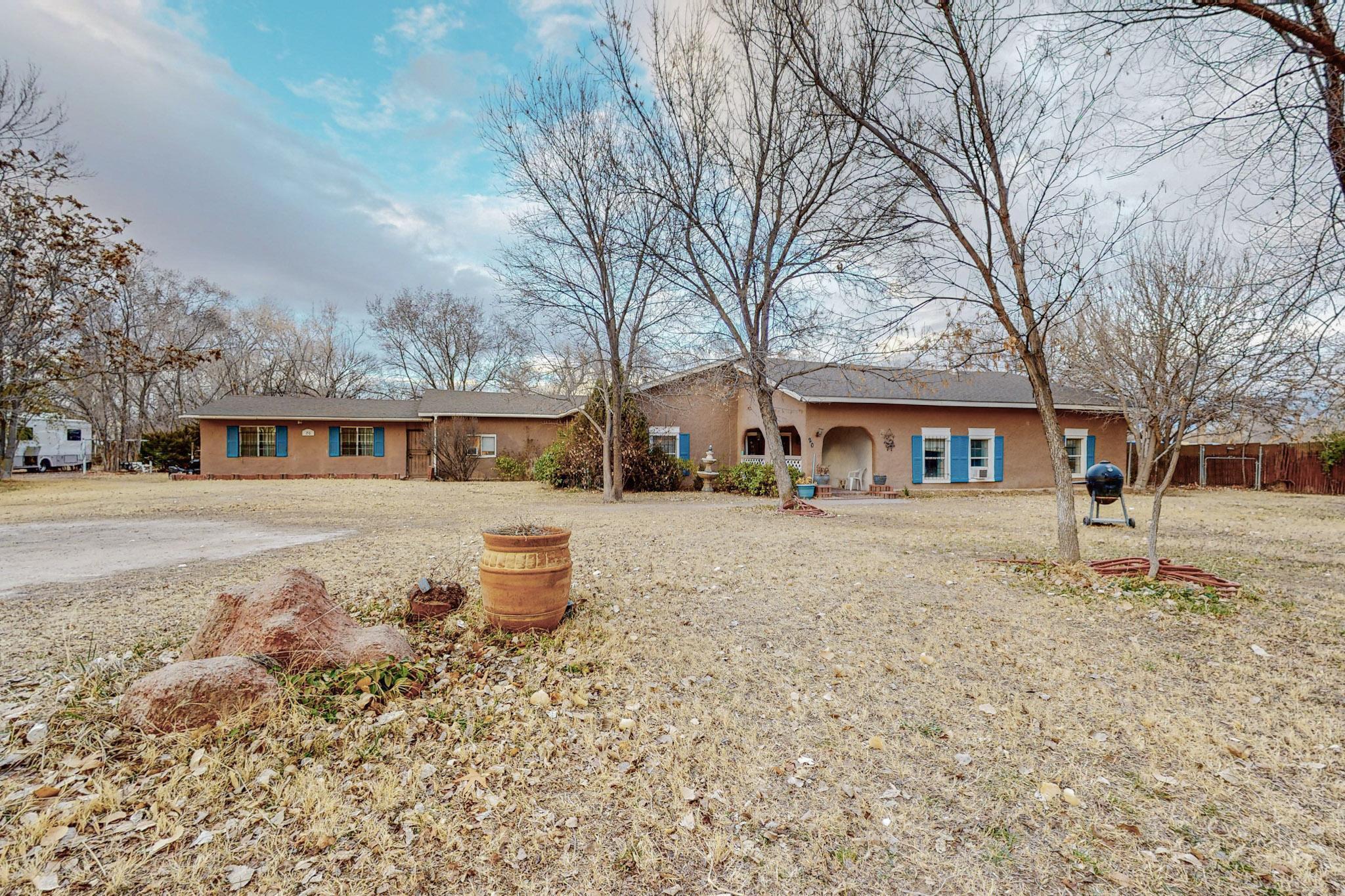 Check out this spacious home on 2 acres in the beautiful greenbelt area of Tome. This home offers over 4,500 Sq. ft including 6 bedrooms, two living areas, and a large kitchen. There is classic New Mexico style charm throughout including Vigas, Kiva fireplaces, and brick flooring. Outside you will enjoy the mature shade trees, and back porch in your quiet valley setting. This property has so much potential with plenty of room for animals and hobbies, whether you add an arena and stalls, gardens, or both! There is also a large bonus structure perfect for a workshop with concrete floors, or to use for a barn. Must see for yourself!