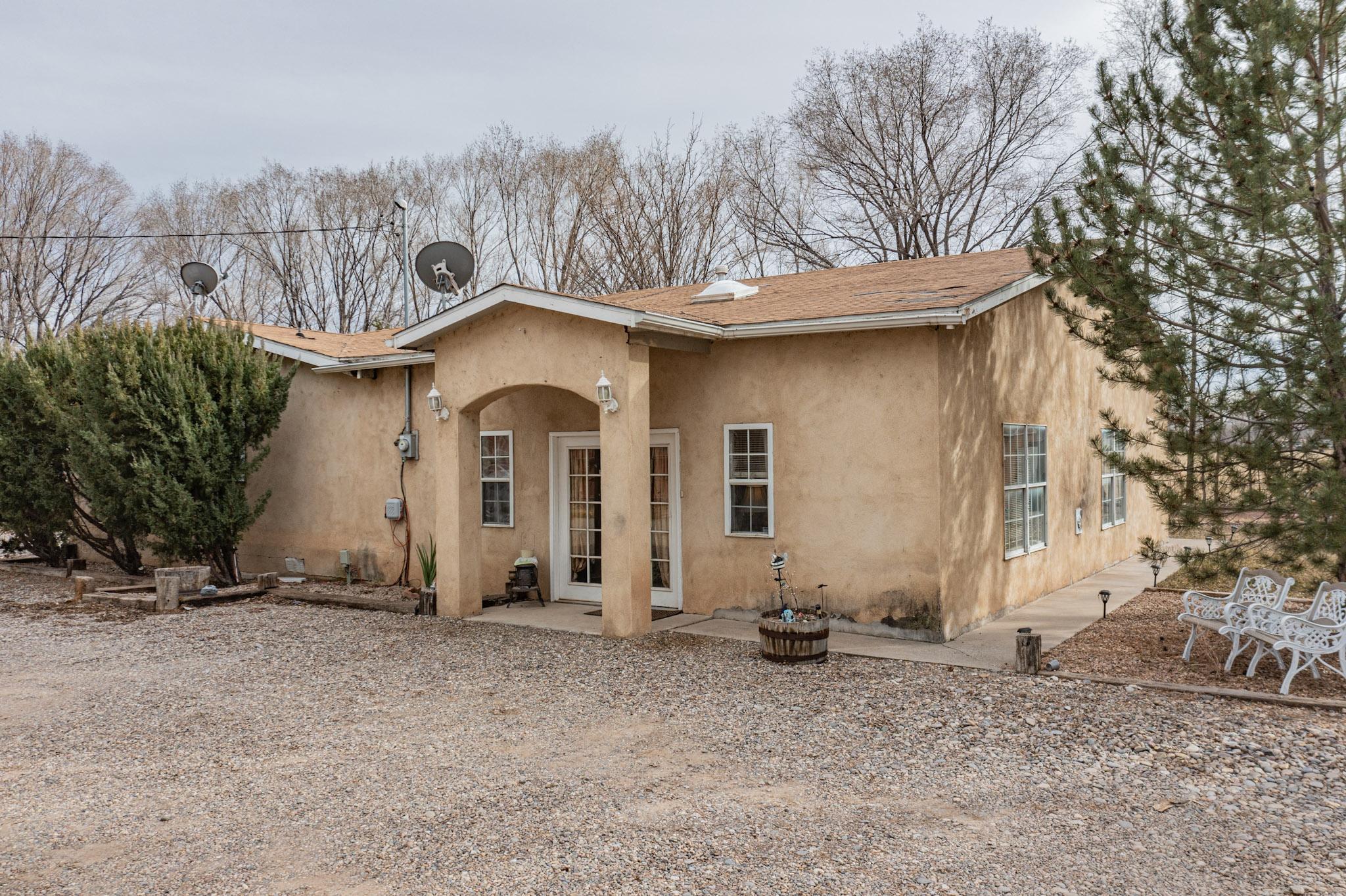 Welcome to this charming Southwest-style manufactured home in New Mexico's South Valley. 3 bedrooms, 2 bathrooms, 2,310 square feet of living space AND a guest home! All on a permanent foundation! Step inside to discover an inviting interior adorned with classic Southwest accents, from warm earth tones to rustic details. The open floor plan creates an airy atmosphere, perfect for relaxing or entertaining. The master suite offers a peaceful retreat with an en-suite bathroom, while two additional bedrooms provide flexibility. Outside, the expansive yard surrounded by mature trees invites outdoor enjoyment. Schedule a showing today!