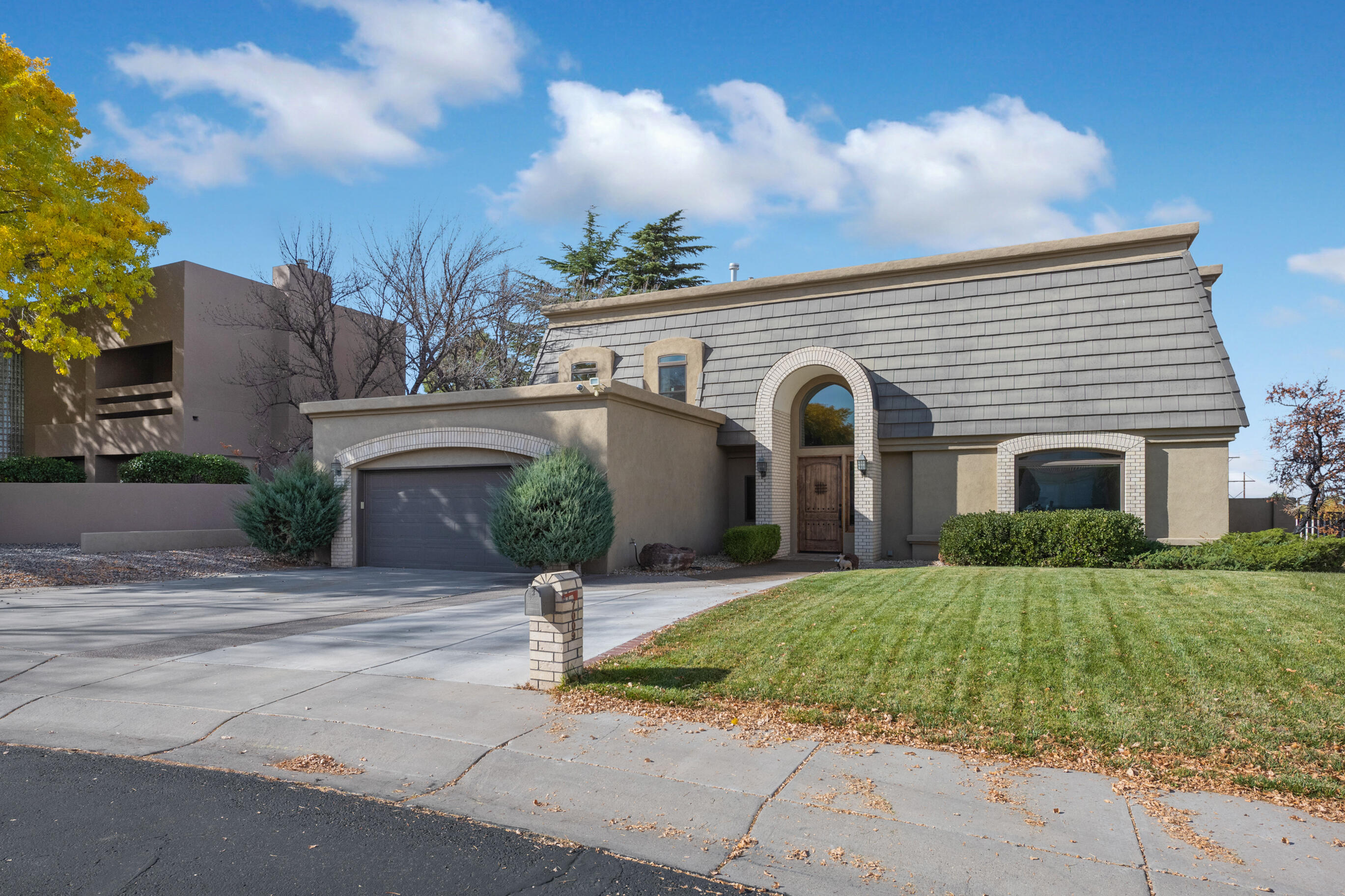 Welcome Home!! This Tanoan Community beauty has been nicely updated!! Custom kitchen with tons of cabinet and counter top space. Lovelygranite, stainless steel appliances, farm sink, large island and a window overlooking the lush green backyard. Lots of windows and skylights for great natural lightthroughout the home. 2 large living areas one has been used as a large office. Huge master suite has a sitting room, perfect for an office, with cozy fireplace. 3vanities, separate shower with multiple heads, and beautiful soaking tub. Downstairs bedroom adjacent to 3/4 bath, and 2 additional upstairs bedrooms with J&Jbath. An extra 1/2 bathroom downstairs for guests too! New TPO roof, stucco and windows in 2020.