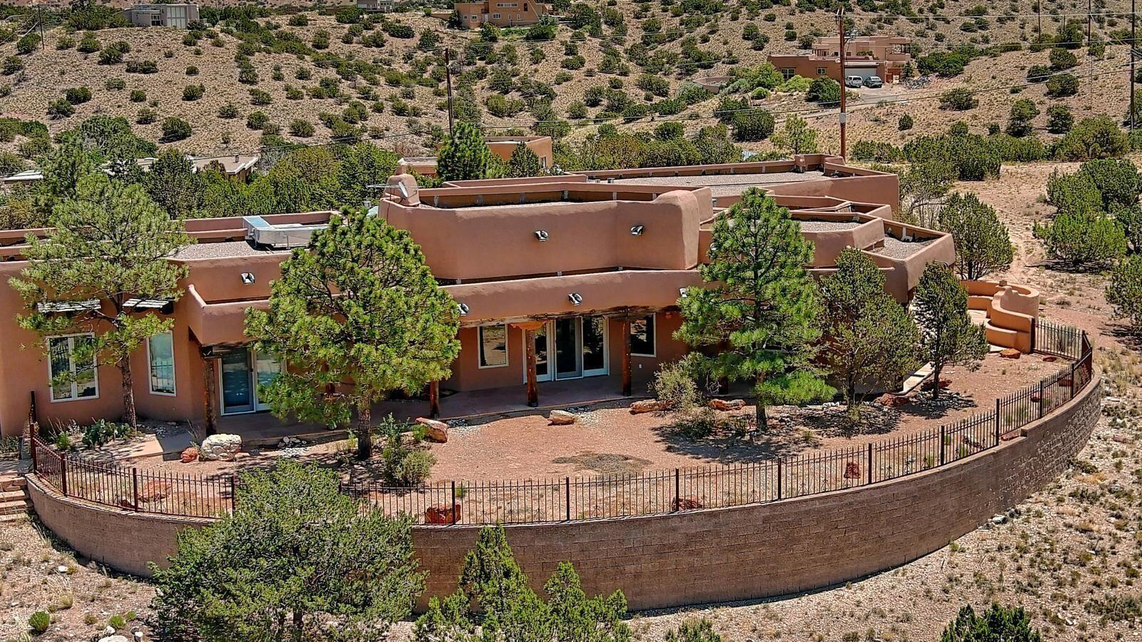 From the Front Door to the Outdoor living spaces, quality is here! This SW Contemporary is Convenient to Santa Fe and Albuquerque!  ONE STORY and Accessible. Amenities and Views Galore! Structolite Plaster Walls,Sandstone Flooring, Kiva Fireplaces, 7000+ sq.ft. under roof! Includes - 4 Car Garage, Portals, & 2 Car Carport. This Enchanting and Stunning Santa Fe Style Home is your next destination in New Mexico. Set in the foothills of the north Sandia Peak Mountains,  Incredible  Mountain, City Light and Mesa Views. New Carpet, Newer Stucco, Easy Concrete Pathways surround the home! Live Beautifully between Albuquerque & Santa Fe. If you are in a 2 story and want an accessible ONE STORY- this is it!