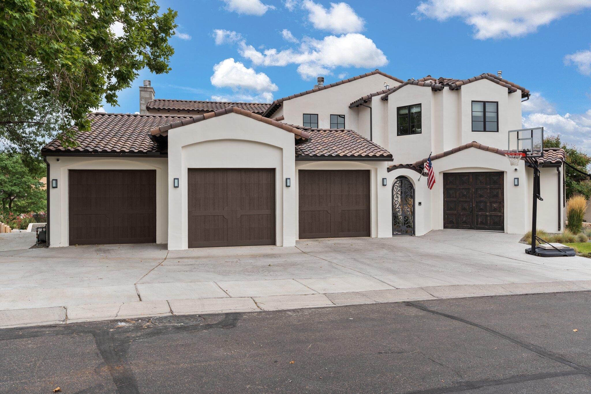 Indulge in the opulence of this exquisite custom built resort style estate, situated right on the tee box in the coveted and guard gated Tanoan community! Every detail exudes luxury and sophistication. Living area with soaring ceilings lined by hand carved beams and built-in bookcases framing the custom fireplace. Complete chef's kitchen with designer cabinetry, quartz countertops, high-end wolf appliances, built-in china cabinet and a beautiful island finished in white oak.  Preserve your prized collection of wines in the temperature controlled wine room. Lavish owners retreat with a romantic fireplace, private balcony and spa-like bath! Premier security with exterior rolling shutters! Backyard oasis w/ an outdoor kitchen, two fireplaces, pool & hot tub overlooking the greens & much more