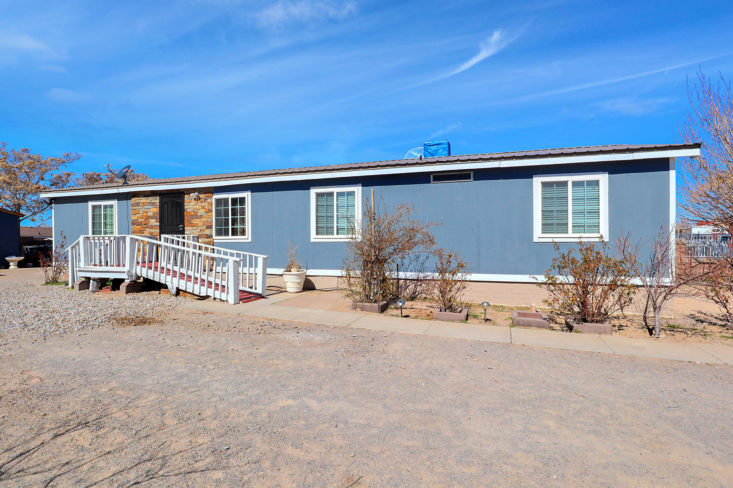 Great property located in the South Valley with easy access to I-25 and only minutes from Downtown ABQ. Enjoy this spacious home with 2 living rooms and a cozy wood burning fire place. Plenty of outdoor space for work equipment, toys, and outdoor activities. It is on a permanent foundation with a deactivated title.