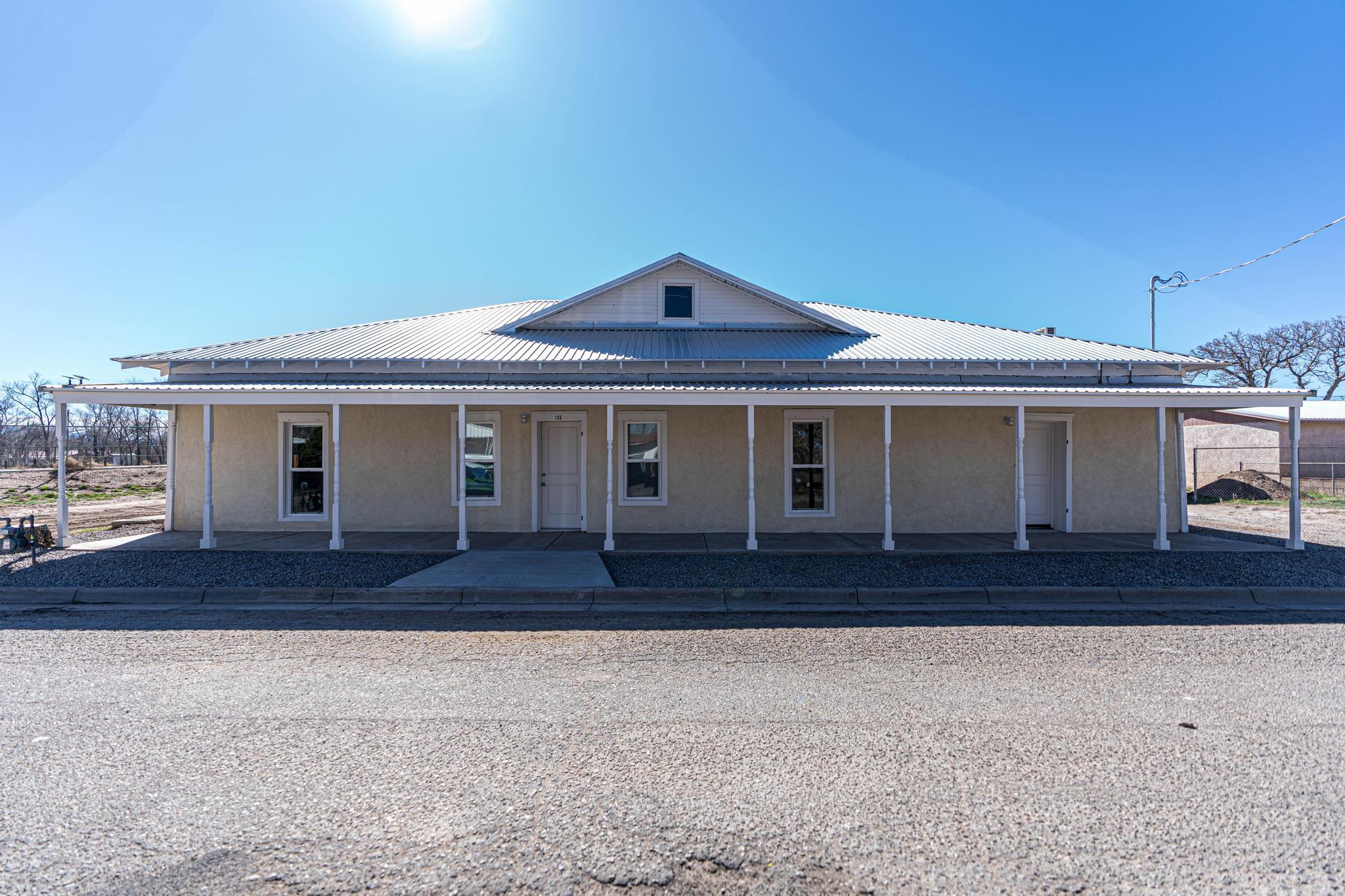 Beautifully updated adobe home on a large .29 acre lot in the heart of Belen.  Big kitchen with quartz countertops, subway tile and all new appliances perfect for entertaining. New windowws and  mini splits in each room will keep everyone comforatable. Large unattched garage with additional room in back is perfect for hobbies or has potential to be turned into casita. Room for all your toys with backyard access.