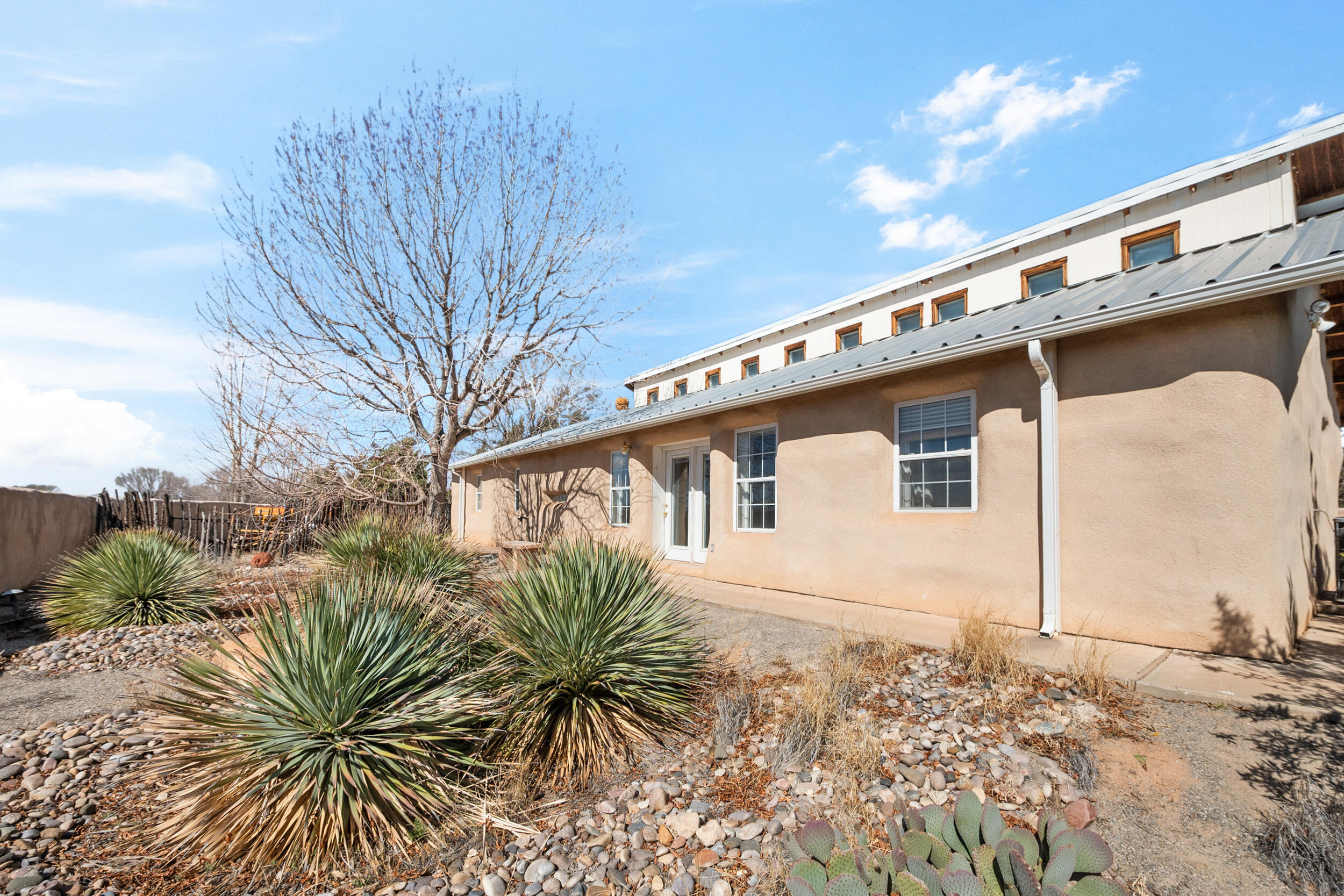 Nestled on a sprawling 3.40-acre parcel, this charming home offers an idyllic retreat with  views of Tome Hill. The property boasts irrigated land with accompanying ensuring a lush and verdant landscape. With 1634 square feet of living space, the residence features raised wood ceilings and an inviting open floor plan that seamlessly connects the living, dining, and kitchen areas. A detached 2-car garage with a workshop area provides ample space for projects and storage. Noteworthy eco-friendly features include owned solar panels and green built insulation contributing to energy efficiency. Embrace the tranquility of country living, where the expansive outdoors becomes an extension of your home. The property is perfect for horse enthusiasts!