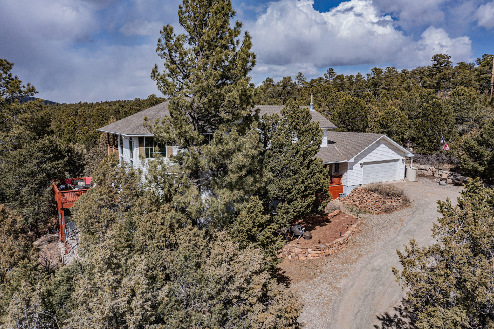 Beauty and spaciousness can be yours. Custom-built home borders the Cibola Ntl. Forest minutes from ABQ! A blend of solitude and breathtaking views from 3 private decks plus ample living space and abundant light make it a must see. The 2,800 sq. ft. floor plan has hardwood floors and a beautiful vaulted ceiling w/ large west-facing windows. Formal dining room, large kitchen and island, cooktop w/ double oven, granite counter tops make entertaining a joy. An off-kitchen deck faces Cedro Peak and the Sandias. Downstairs master suite, two upstairs bedrooms and office plus fast Internet connectivity are perfect for working from home. A new storage outbuilding, basement exercise room and workshop space all add to the attractiveness of this choice property. Additional acreage is also available!
