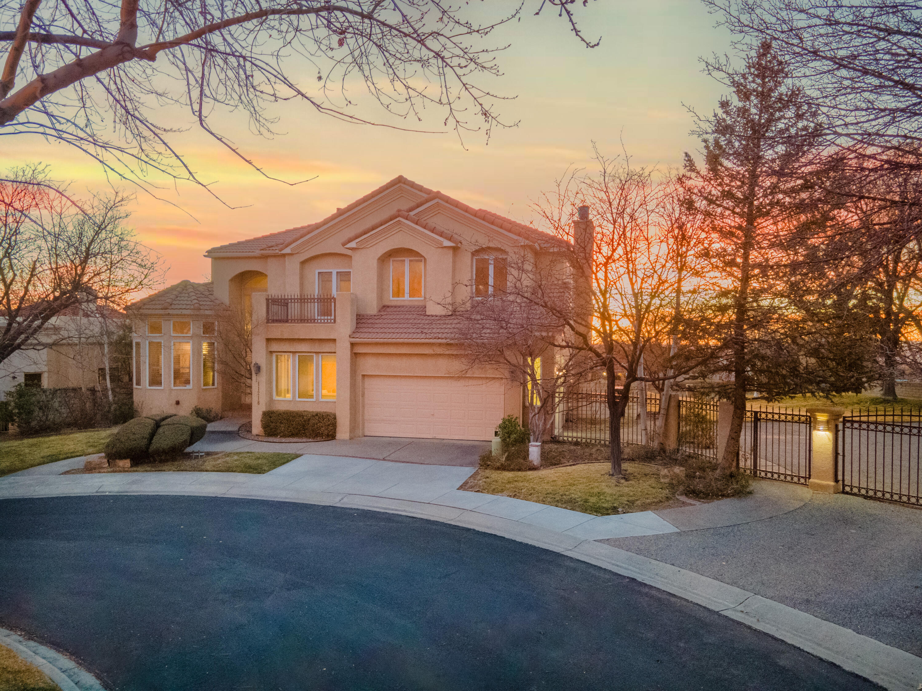 Elegance and comfortable living come together in this luxurious home positioned on the Tanoan Golf Course. Views surround this home: majestic mountain, city and extended fairway. Exceptional opportunity to enjoy the ownership of adjoining lot (.2 acres included in price, so total .37 acrs) as part of the outdoor living space in this prestigious gated community. Dramatic architecture & gorgeous landscaping unfold from this 5 bedroom, 4.5 bathroom home, nestled on a cul-de-sac lot. Upon entering the home, a chandelier suspends from the high ceiling as you step onto the walnut wood floors. A sweeping staircase opens to the formal dining and living rooms. Designer kitchen displays custom white cabinets with chocolate glazed finish, granite counters, island with gas cooktop & butler's pantry