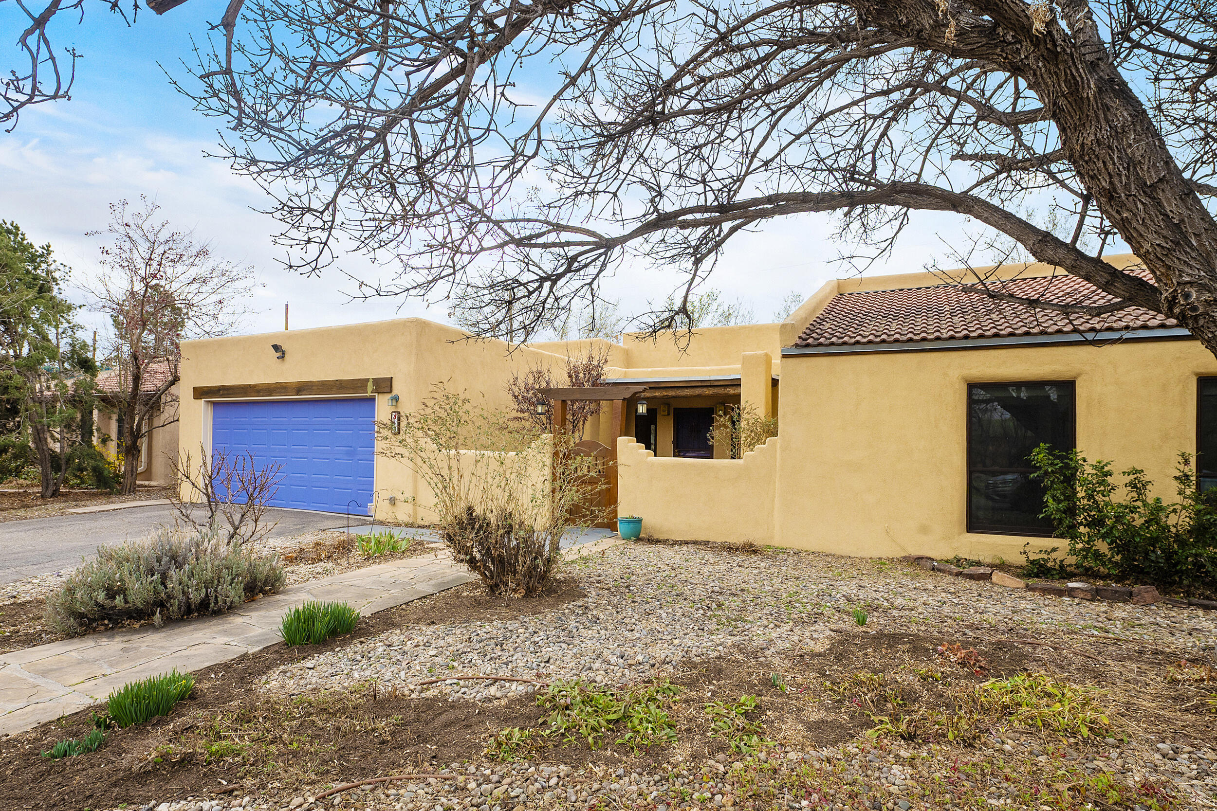 Come home to this quiet, peaceful North Valley cul-de-sac neighborhood. This home exudes charm with the beam ceilings, exposed adobe walls, brick floors and a kiva fireplace! Additional amenities include passive solar trombe walls, baseboard and forced air heating and refrigerated air! Quality throughout the home includes Anderson and Eagle windows. The roomy kitchen will take your breath away! The expansive great room looks out over the very special, serene back yard with a vine covered tall fence. Enjoy your morning coffee on the private shaded patio. This pet friendly home is secure for pets to roam and roll in the flowers and grass! Better hurry to see this one!!