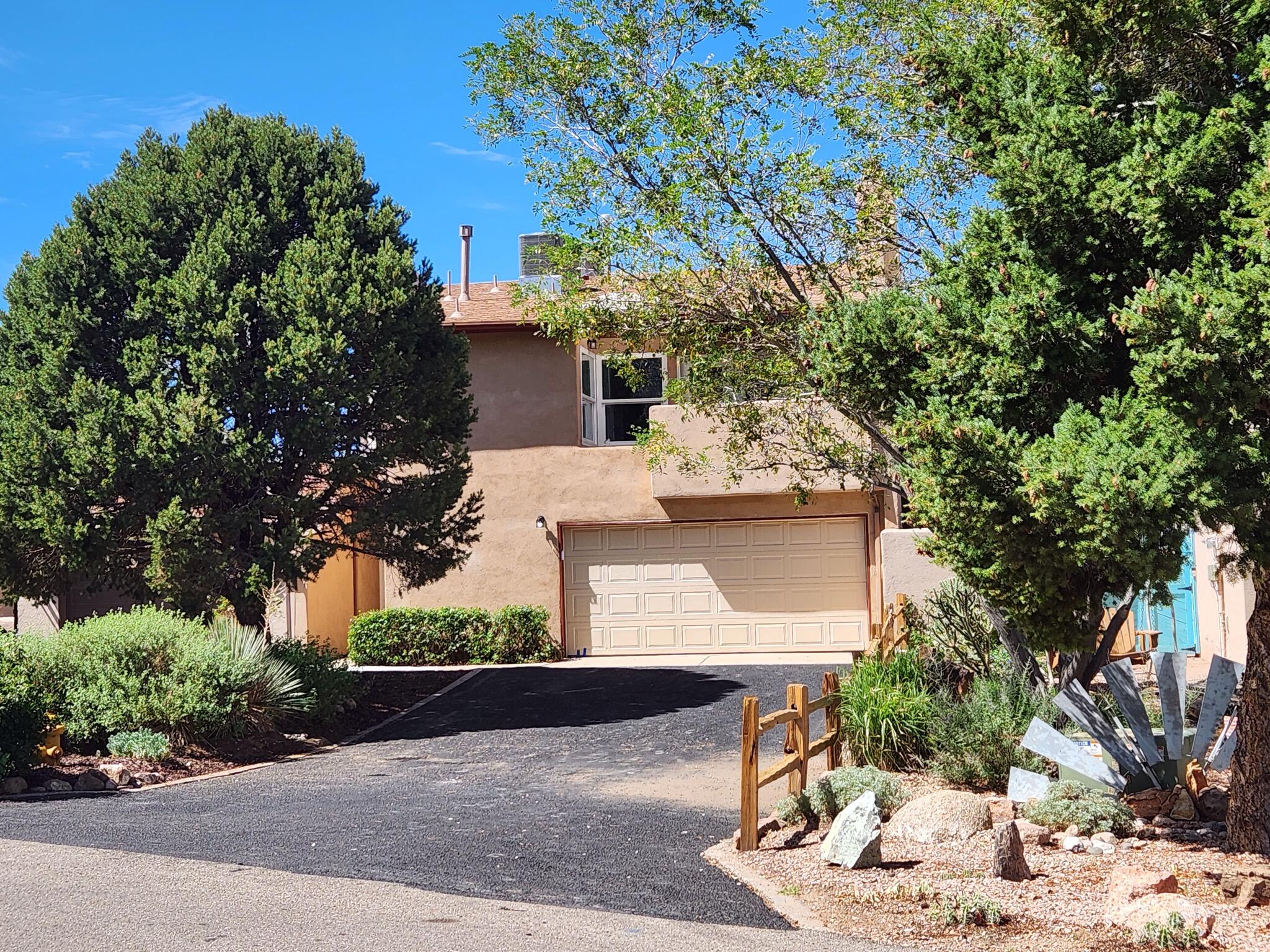 Live above the city in this renovated multi-story Townhome in Sandia Heights that invites New Mexico into your home. Enjoy sunsets and the adjacent park from a private balcony overlooking the city. The primary suite has it's own balcony facing the Sandia Mountains. New (2023) HVAC units, (2023) water heater, new (2023) appliances, new (2023) windows, and new (2023) flooring. The kitchen is completely remodeled with stainless (Samsung) appliances. Kiva fireplaces in the primary bedroom and living room will make your evenings warm in the winter. Two living areas on different levels, one with a balcony and the other with your own private flagstone patio.