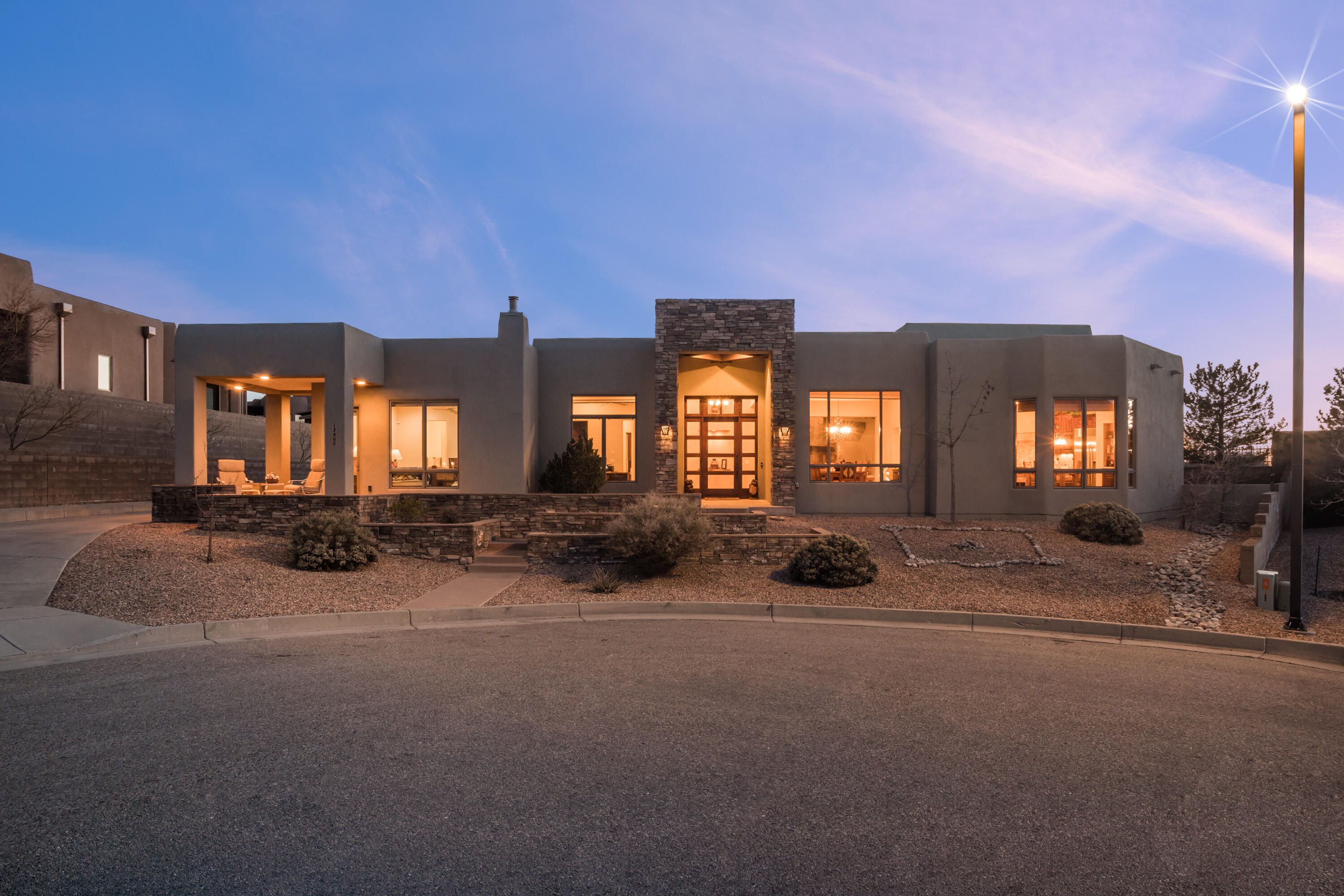 This incredible single story custom home is located at the end of a cut-de-sac backing up to open space within the masterplanned community of High Desert. The home was built to take advantage of the incredible views afforded from this unique homesite. Quality finishes such as slate and hardwood flooring, plaster accent walls, hand stacked stone accents, beautiful beamed ceilings, handcrafted furniture grade cabinetry, rich granite, and Wolf/ Subzero appliances. Dramatic views of the crest of the Sandia Mountains and dramatic sunsets & city lights can be found from this home. Built entirely on one level, there are no interior steps in this home offering universal accessibility. The oversized 3 car garage offers tons of storage. Enjoy hiking, biking & walking trails right outside your door.