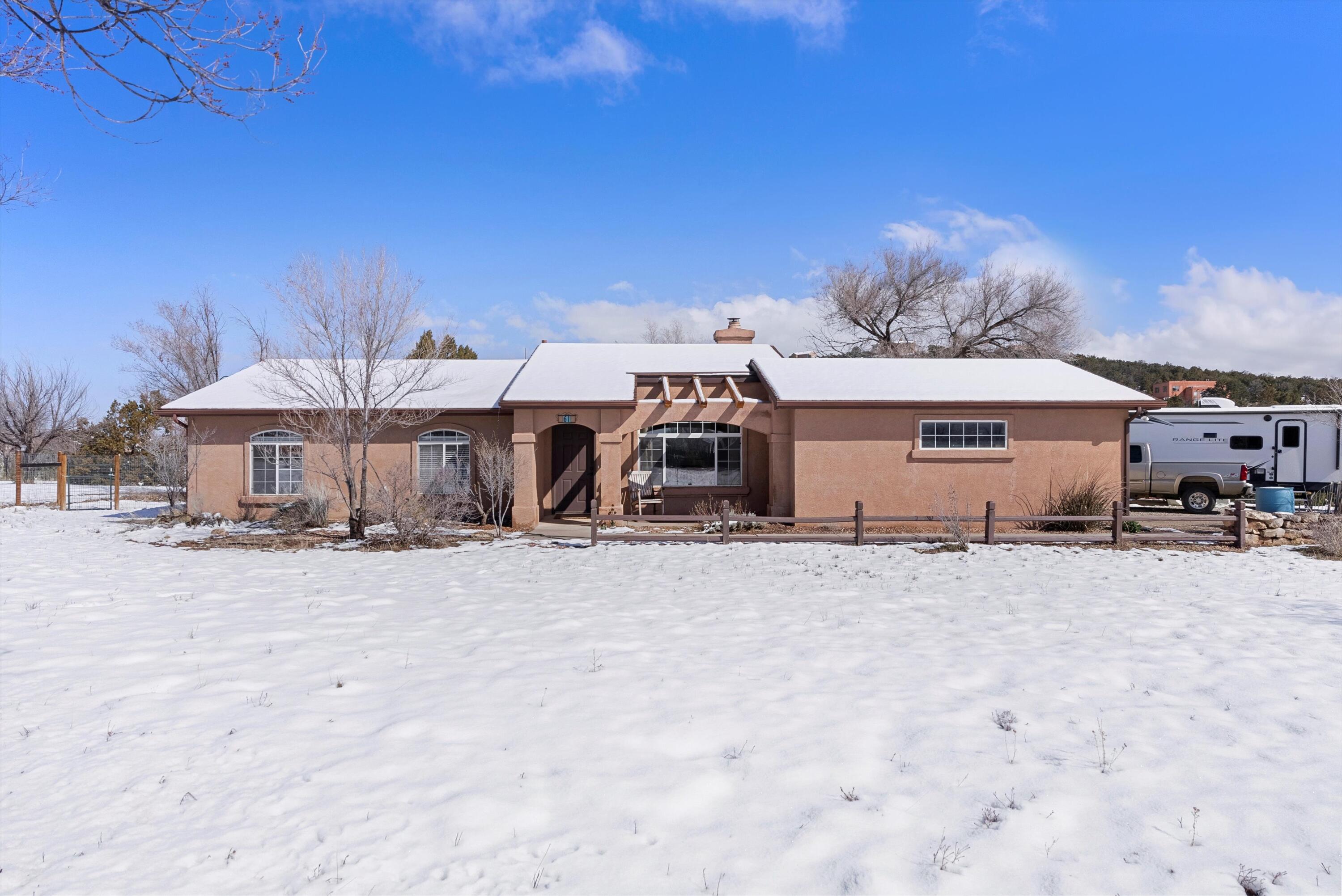 This charming home on Dinkle Road offers a perfect blend of comfort and tranquility. Situated on a spacious 2.29 acre lot, this property is a true gem in the heart of New Mexico. Step inside to discover a well-maintained single-story home with 3 bedrooms and 2 bathrooms. This home features a reverse osmosis system, new water hear (2023), tile and hardwood floors. Outside, the property features a barn with 2 stalls for your horses. Enjoy the country evenings on the covered patio.