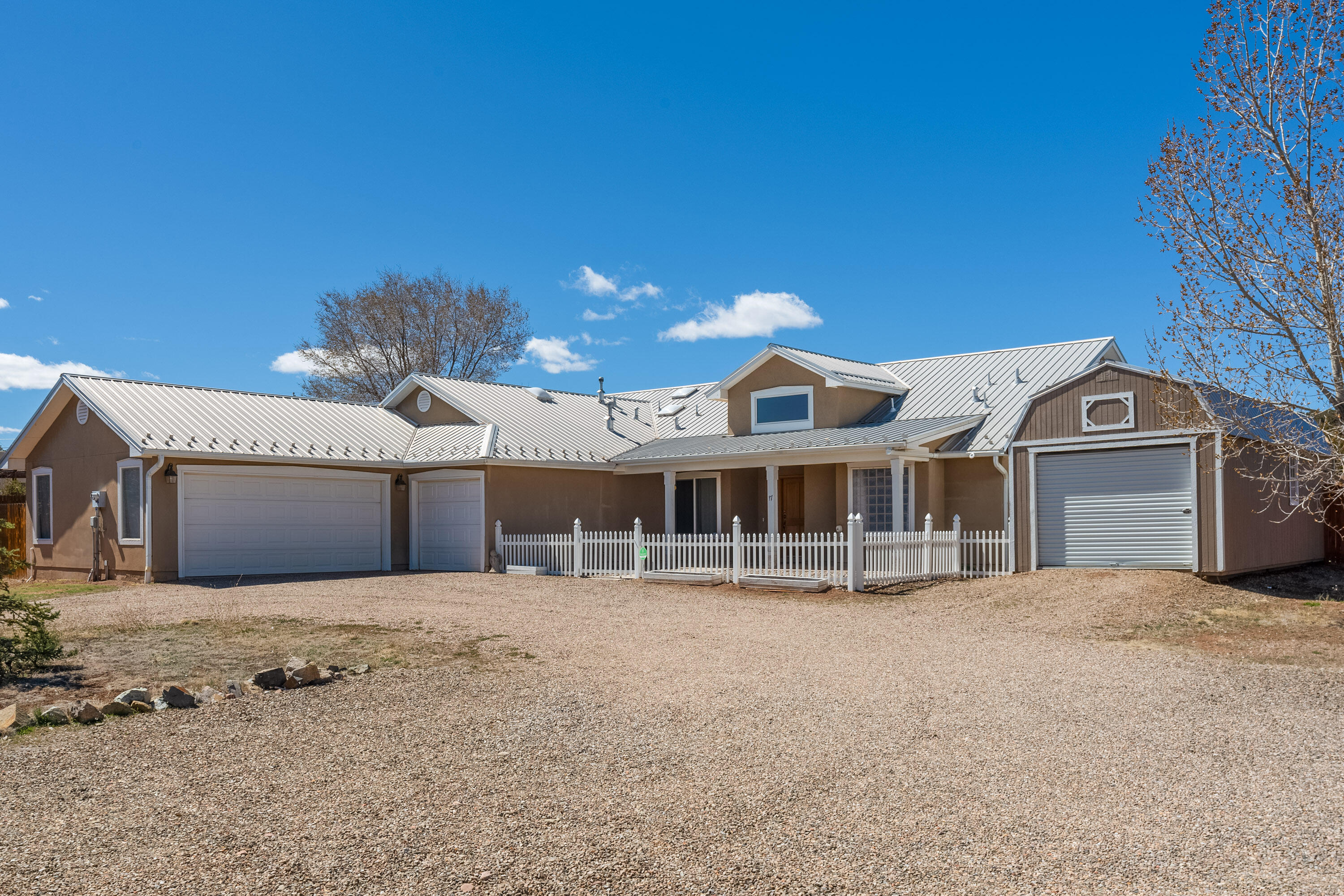 What a great escape from Albuquerque! A northern New Mexico style on treed 1 acre lot includes insulated 3 car garage w/separate 15X15 workshop, RV pad w/50-amp service & 12X32 shed w/roll up door. Wood beams, corbels, vigas, & nichos accent the open floorplan. In the heart of the home, a sophisticated kitchen w/ island, granite counters, bar seating & opens to gracious breakfast nook & entertaining areas. Spacious, light filled living area w/vaulted ceiling, pellet stove & formal dining. Primary suite has door to the back patio, large walk-in closet, & luxurious bath w/soaking tub, separate shower & 2 vanities. Covered patio & fenced courtyard in front with no maintenance rock. Lg fenced backyard w/native grass, plumbed for sprinkler. You'll want to make this your home!