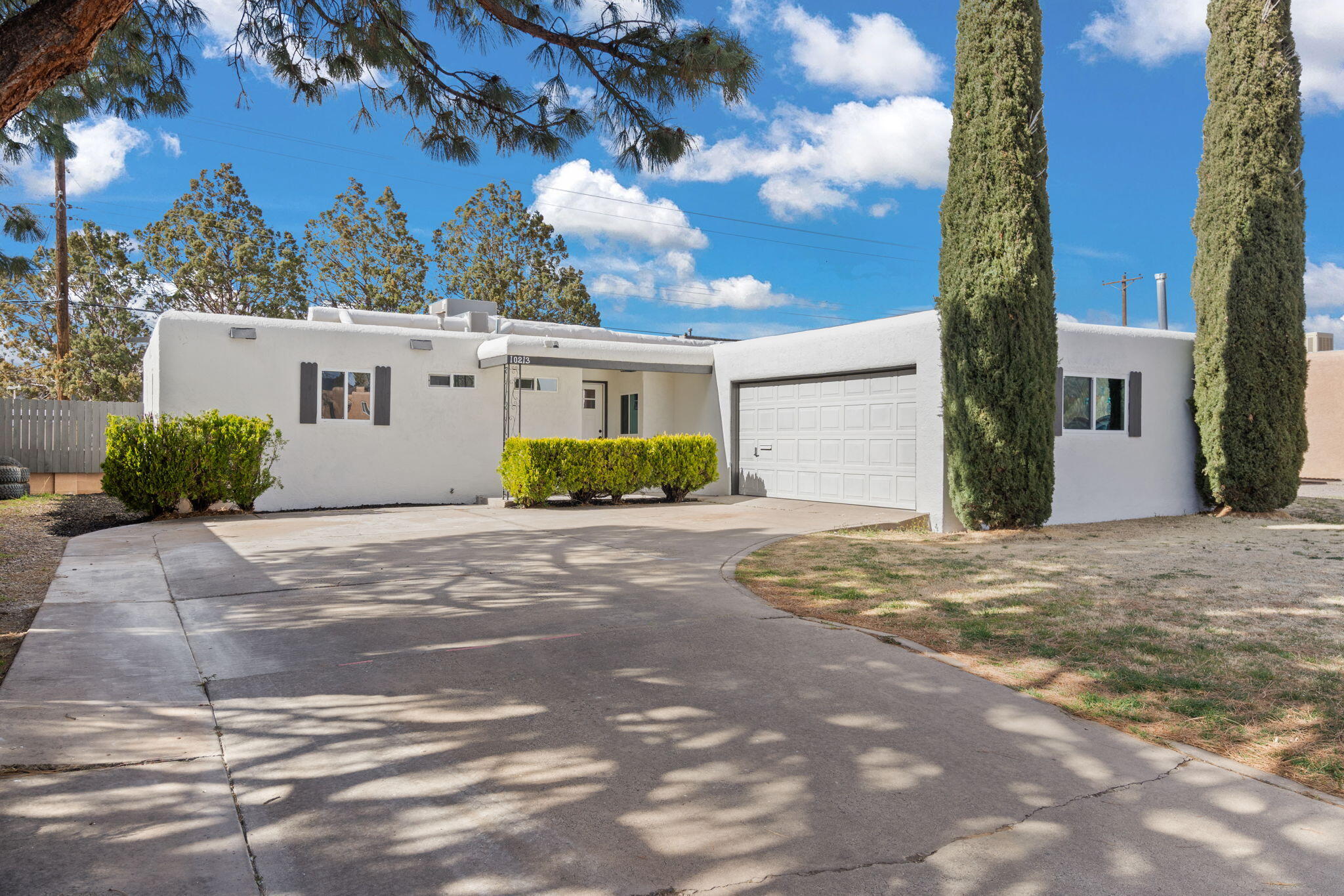 Stylishly transformed! Fully renovated finishes and upgrades to this Northeast Heights home. Waterfall kitchen island and classy blonde luxury vinyl, fills the home with new windows and a chic wood burning fireplace. Brand new refrigerated combo unit, fresh paint, and crisp gold finishes to bring class and character to this Albuquerque gem.