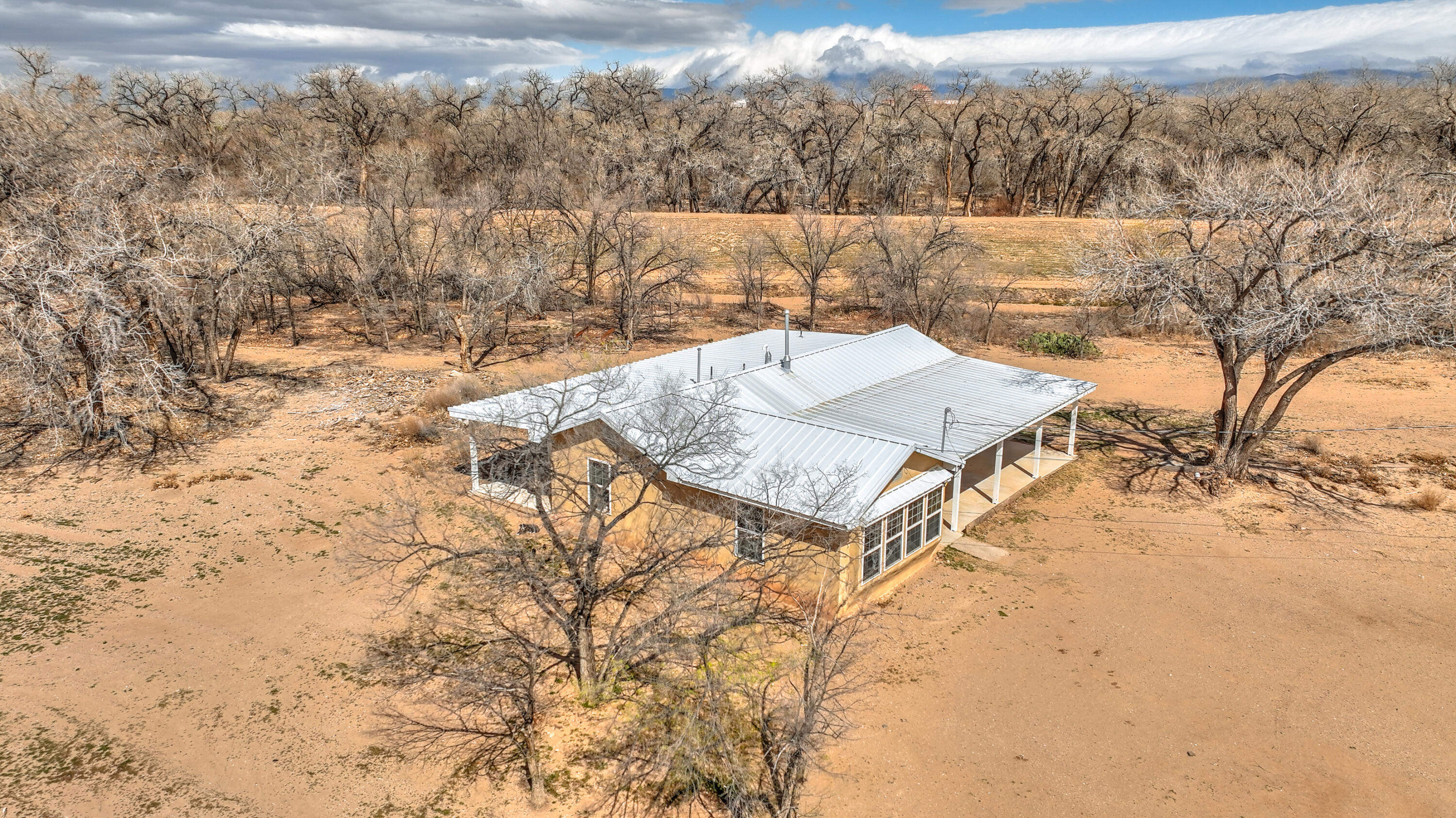 A Rare Find in Albuquerque! This Northern New Mexico Ranch Style Home, WITH 3.81 ACRES, ON THE BOSQUE, is only 3 miles to Downtown. Adjacent to Valle Del Bosque Park and Open Space, Bridges provide easy access into the Bosque and Hiking Trails. Got Horses? A Farm? A Vineyard? Currently A-1 zoning!!! Or Rezone to R1 and subdivide. Opportunities are endless!