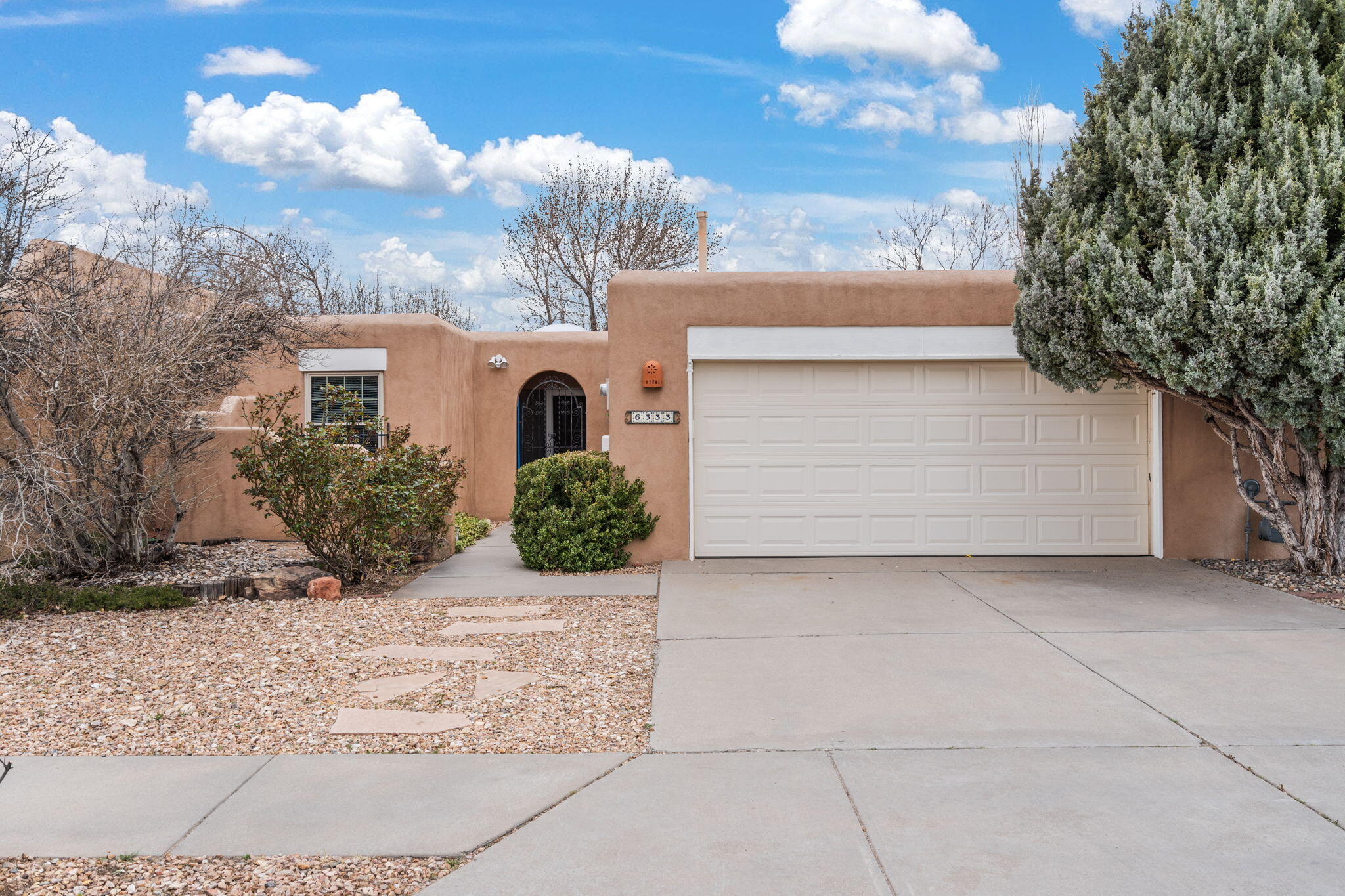 Lovely stucco home in convenient location across from Tanoan. Custom Kiva fireplace and beautiful beams in spacious living room. Skylights throughout home including mini greenhouse area. Home has newer roof , furnace and water heater. Private courtyard and lovely covered patio. Oversized two-car garage.This is the new home you have been looking for,