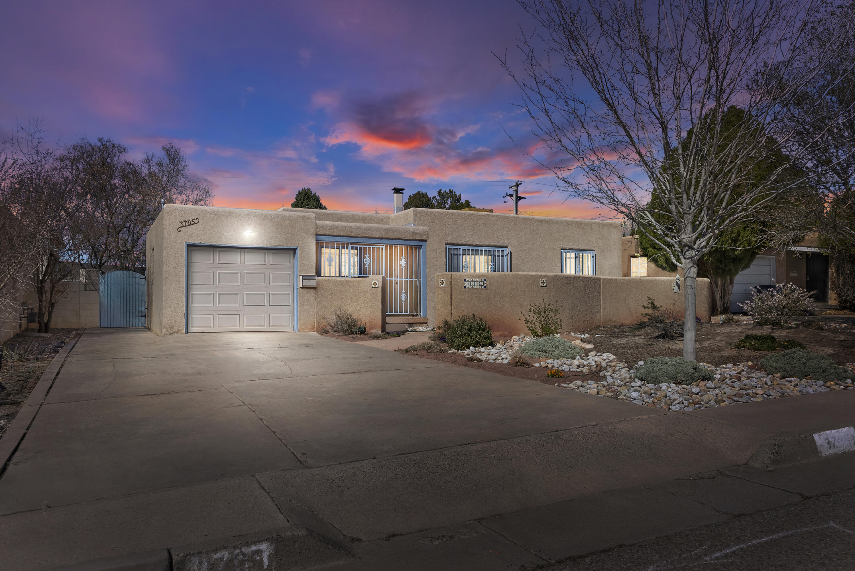 This one-story house near the University of New Mexico is a classic example of mid-20th-century architecture, built in 1952. The home spans roughly 1300 square feet and features a blend of traditional charm and modern convenience, suitable for those who appreciate the character of older homes coupled with the benefits of living close to a university campus.As you enter the property, you'll be greeted by a quaint exterior that reflects the design aesthetic of the early 1950s, with mature landscaping that hints at the home's established history. An attached one-car garage provides off-street parking, an appreciated feature in the university area where parking can be a premium.Stepping inside, the house reveals an open floor plan connecting the living and