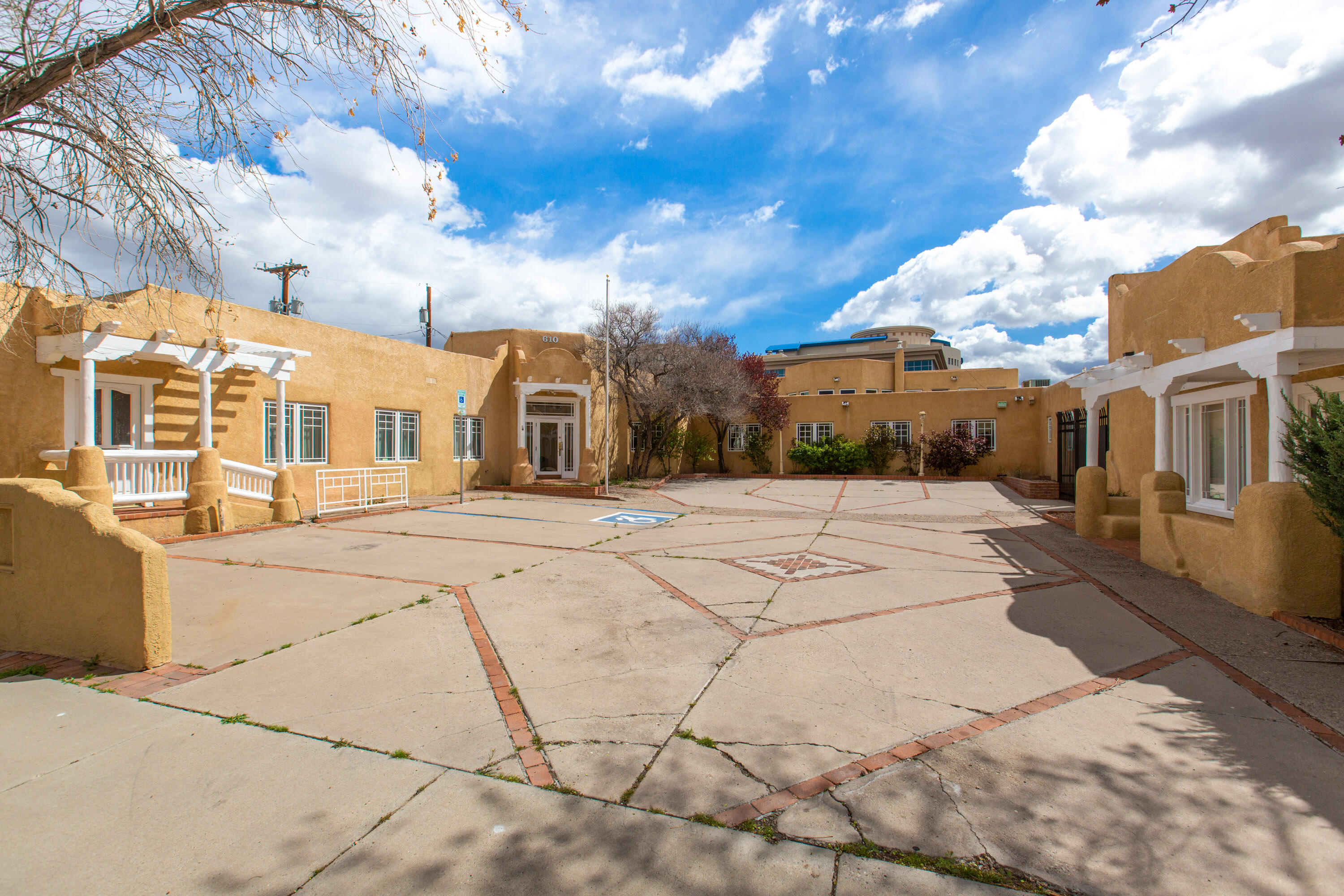 Historic gem in the heart of the downtown! This sprawling suite of offices was converted from four early 1900s pueblo-style homes and served as the headquarters for one of Albuquerque's top law firms for more than 40 years. Ideally located blocks from the Courthouses, this property provides ample off-street parking within a lovely walled courtyard. Currently designed with 8 executive offices, 4 support staff offices, 3 conference rooms, 2 reception areas, 4 bathrooms, 2 basements housing mechanical systems, a break room/kitchen, storage room, and lovely covered and gated patio, this property is ready for move in or reconfiguration to fit any need. This unique property is priced below appraised value and ready for a new enterprise!