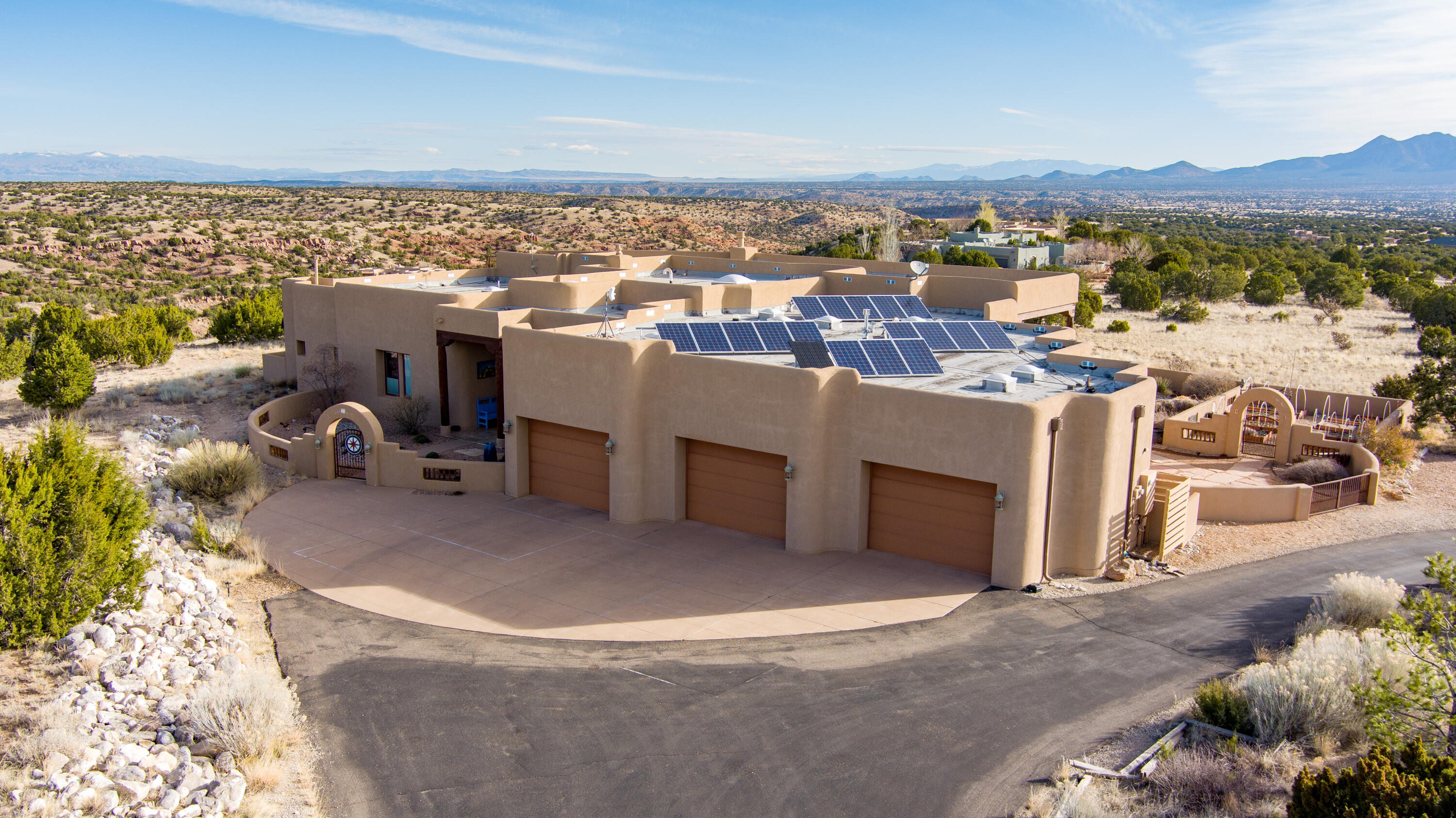 Open House Sun, 4/28, 11-1pm. Welcome to your dream eco-friendly oasis in the heart of the Southwest! This Certified Green Built home boasts upscale design and luxurious features throughout. Step into the lovely courtyard and walk inside the impressive foyer...you will be greeted by the spacious greatroom with 12ft ceilings & kiva fireplace, perfect for entertaining guests. The huge kitchen is a chef's delight with high-end appliances and ample counter space & cabinets. Every window in the home offers breathtaking Mountain Views, creating a serene backdrop for daily living. Step outside to enjoy the outdoor kitchen, with kiva fireplace and covered patio with 14' tongue and groove ceilings, perfect for al-fresco dining.  Home features 3 bedrooms plus an office/media room...(con't)