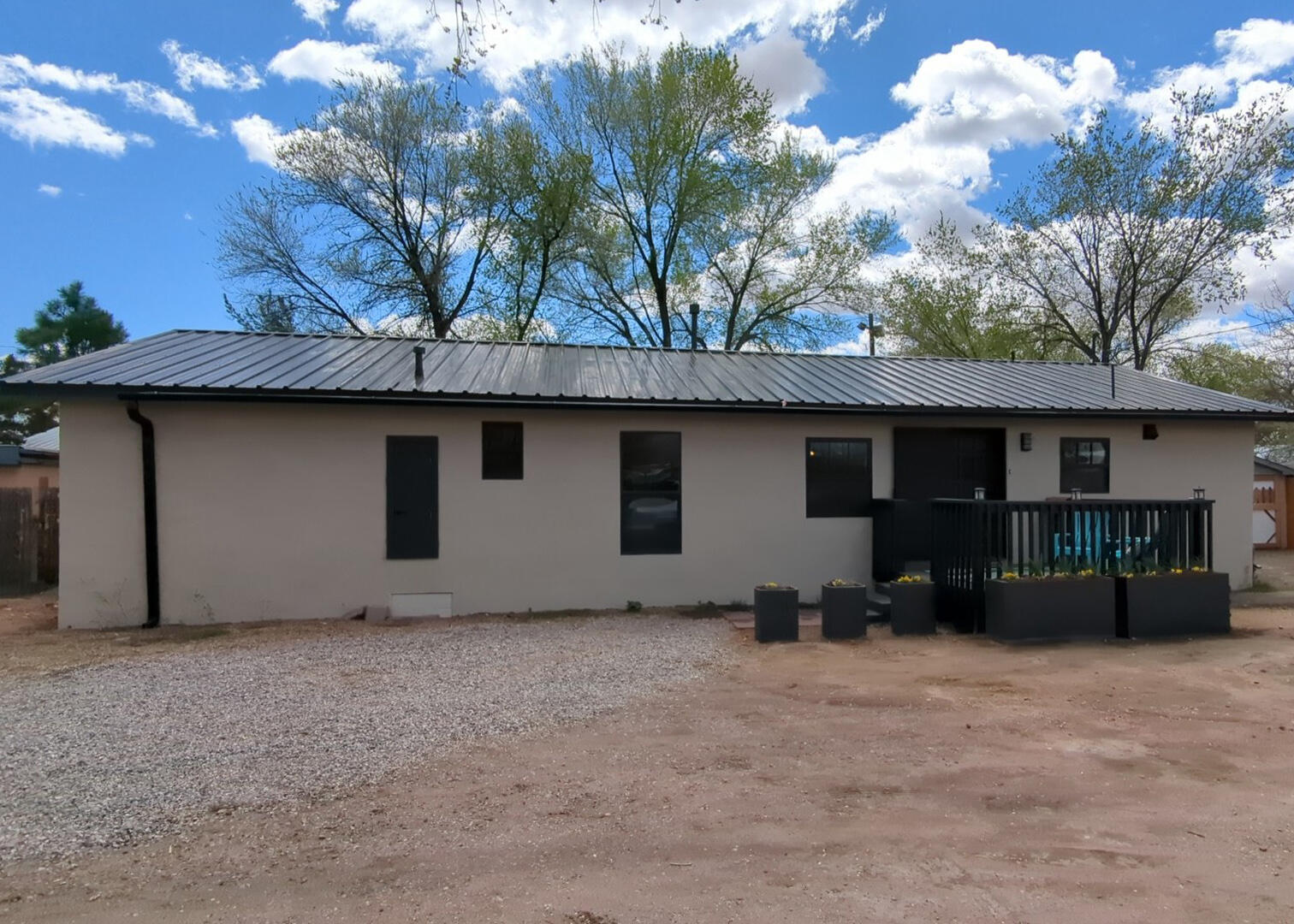 Lender financing available for qualified buyer. Fully remodeled, fresh paint, flooring, bathrooms, windows.  On a private road with a fenced back yard.  Very quiet and calm.  Nice rural neighborhood to walk in.  Close to the Rio Grande and Bachechi open space and the Bosque trail.