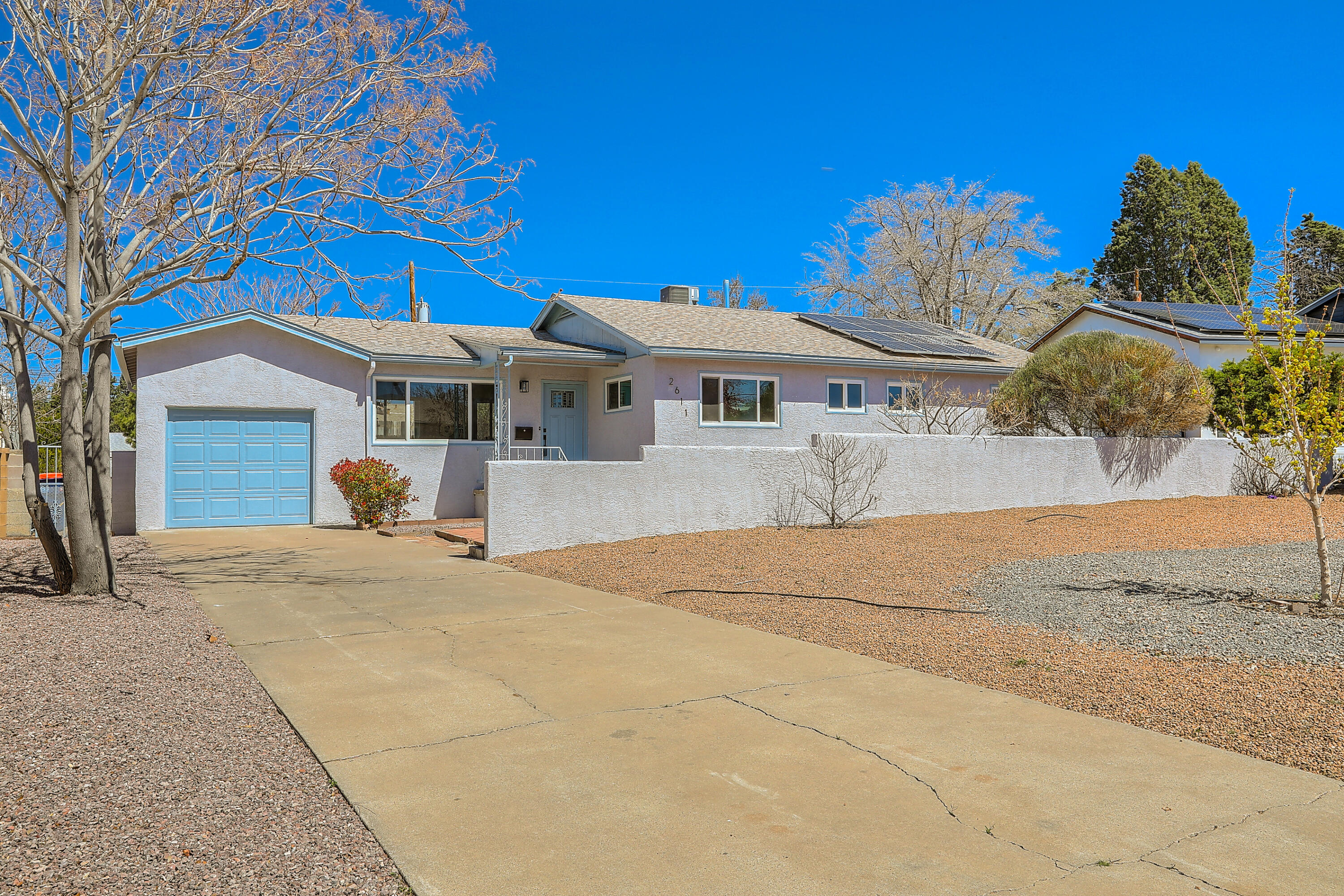 Charming home near UNM area boasts newly remodeled features including refinished hardwood floors, updated cabinets, quartz countertops, and custom tile work. Enjoy the convenience of walking to parks, restaurants, and the university. With paid-in-full solar, this home offers both modern amenities and sustainability.