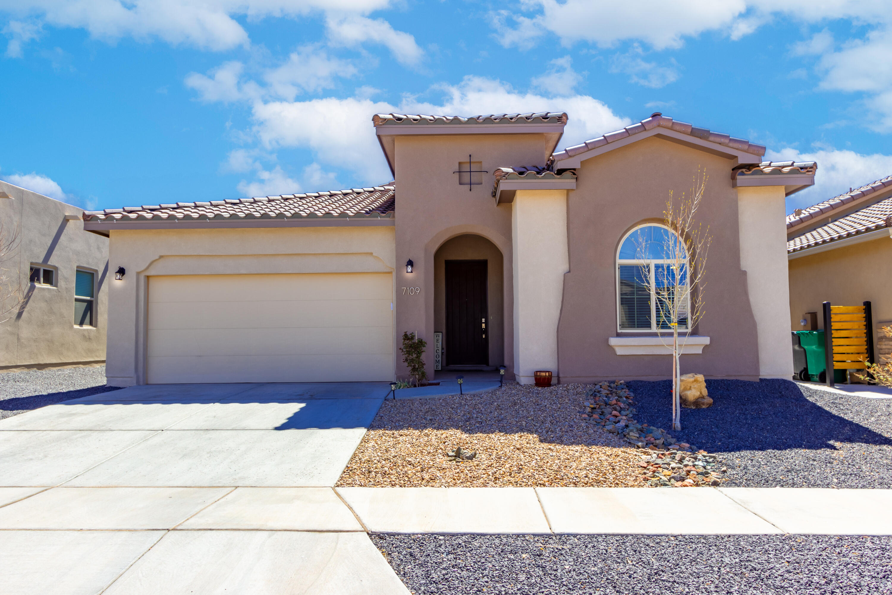 Experience sophistication in Lomas Encantadas. Conveniently located near shopping, restaurants and freeway. This contemporary gem from 2020 offers luxury features tailored for today's homeowner. The spacious living/dining area boasts beam ceilings and modern wood finish tile flooring. The open kitchen features a large island with bar seating and unique pendant lighting with a farmhouse sink, a cooktop and built in appliances.  Staggered white cabinets are accented by a custom tile backsplash. The bedrooms have carpeting and tray ceilings, with the primary suite including double sinks, a separate shower, and a generous walk-in closet.Outside, the tranquil low-maintenance backyard, complete with a covered porch, invites relaxation amidst stunning views.