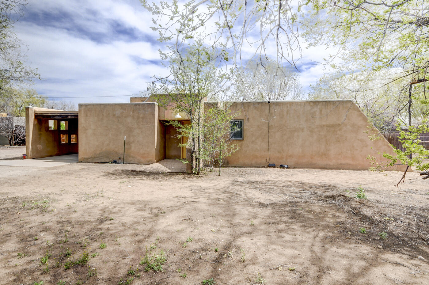 Rare Find in Fantastic Area! Nestled on .34 of an acre near the Rio Grande Nature Center and Endless Trails! Renowned Architect Hildreth Barker designed and built this Intriguing Home for himself! Open-concept home boasts a unique step-down Conversation Pit Living area with a built-in Banco & Kiva Fireplace! Hardwood floors & built-in bookshelves in the flex space, which is open to the Dining area! The Sunny Kitchen offers abundant fresh painted Cabinetry+New Stove! Bedroom has a built-in bed platform! Bath features a large shower/tongue & groove wood walls! LOFT area Bonus Space, not in SF. Live happily in this home forever, or keep it as a casita & build your dream home! Thousands in NEW UPGRADES: Designer Lighting! LVT Floors! Carpet! Fresh Paint! + More! A UNIQUELY FABULOUS HOME!